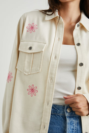 Loren Long-Sleeve Shirt Jacket with Button Closure, Two Chest Button Flap Pockets and a Raw Hem in Ecru Colorway, with Pink Flowers - Front View Featured on Model