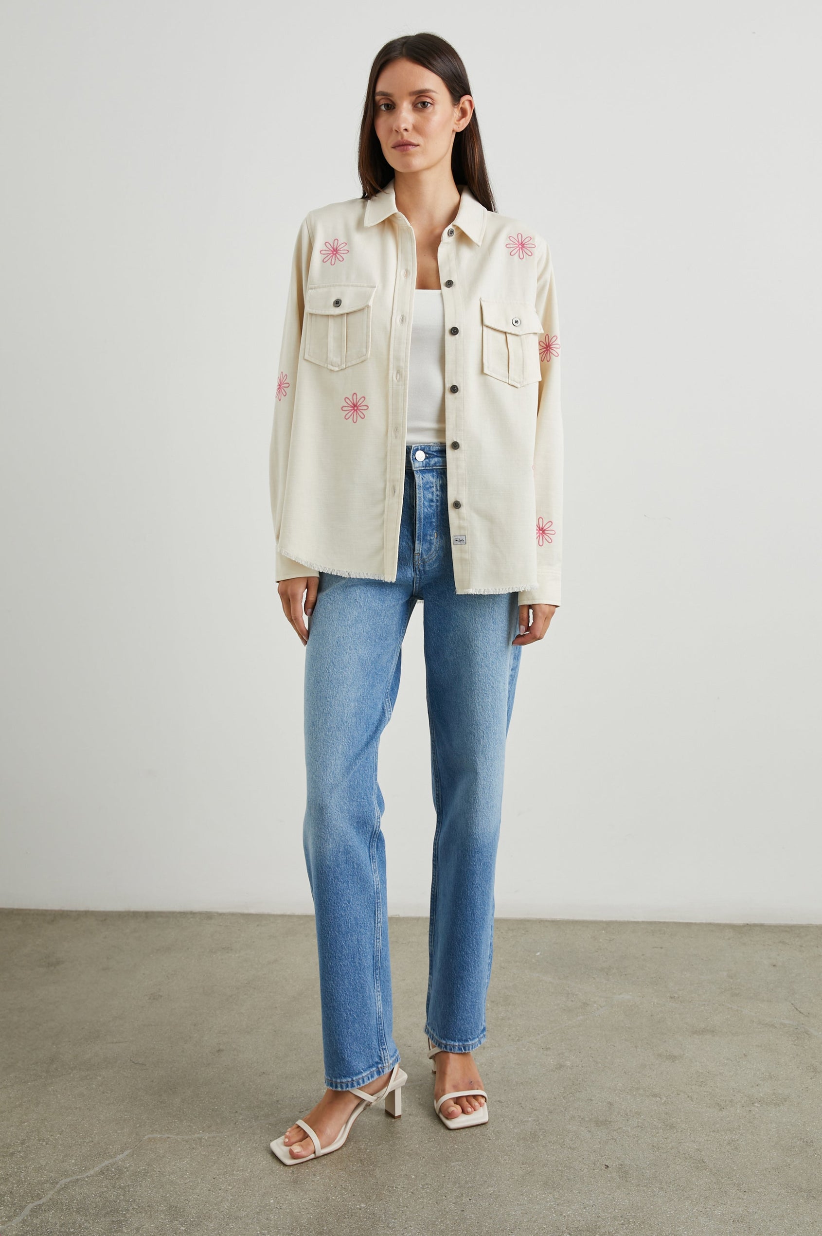 Loren Long-Sleeve Shirt Jacket with Button Closure, Two Chest Button Flap Pockets and a Raw Hem in Ecru Colorway, with Pink Flowers - Front Full Body View Featured on Model