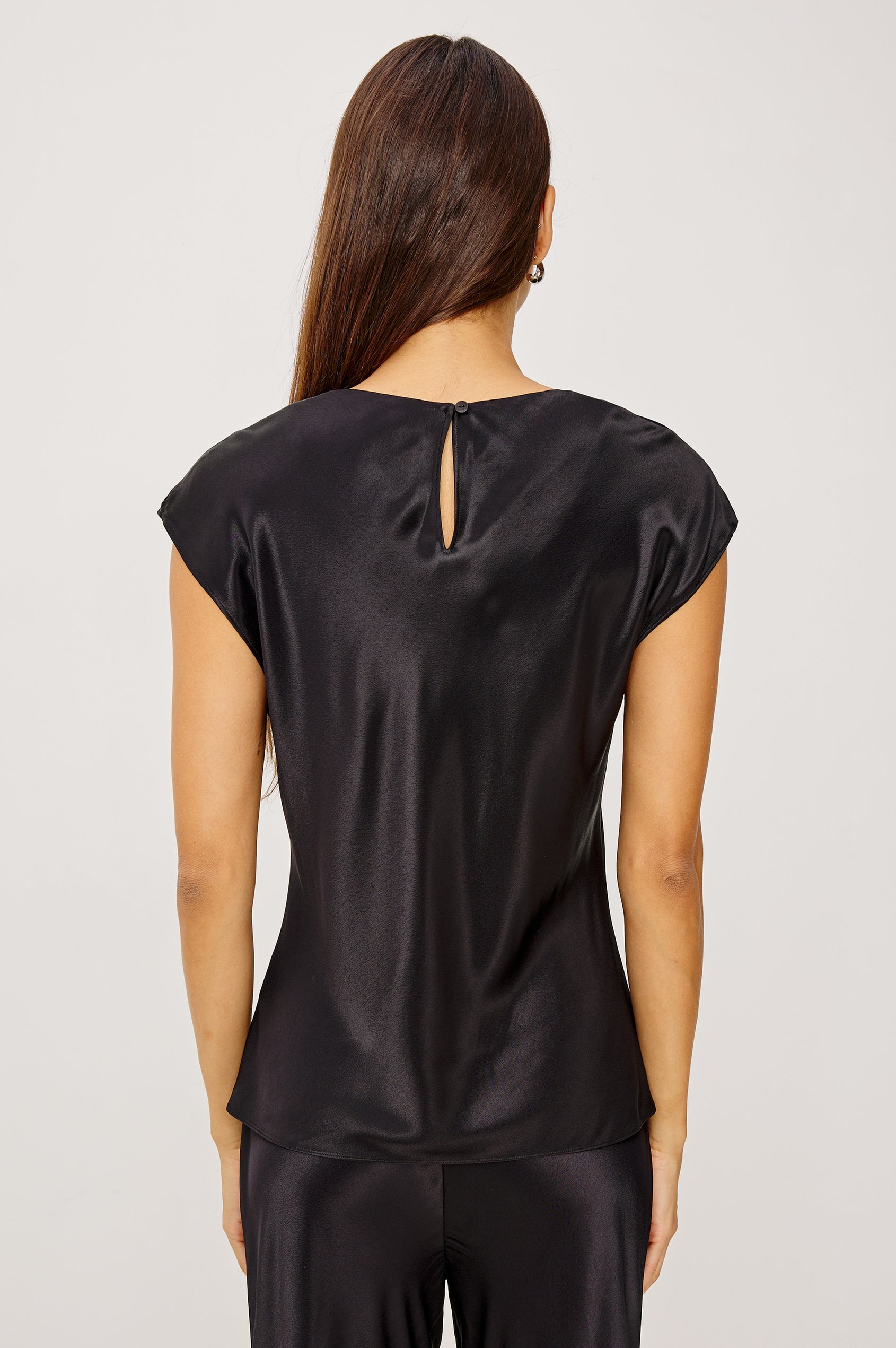 Loretta Top in Satin Back Crepe With a Loose Fit, Cowl Neckline, Cap Sleeves, and a Back Keyhole Button Cutout in Black Colorway - Upper Body Back View Featured on Model