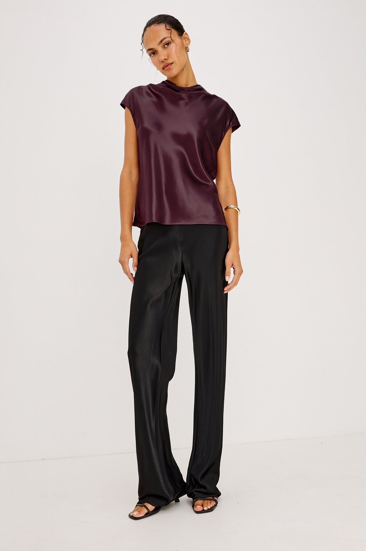 Loretta Top in Satin-Back Crepe With Cap Sleeve, Mock Neckline, Straight Hem, Keyhole Back, and Button-and-Loop Closure in Wine Colorway - Front Full Body Detail View Featured on Model.