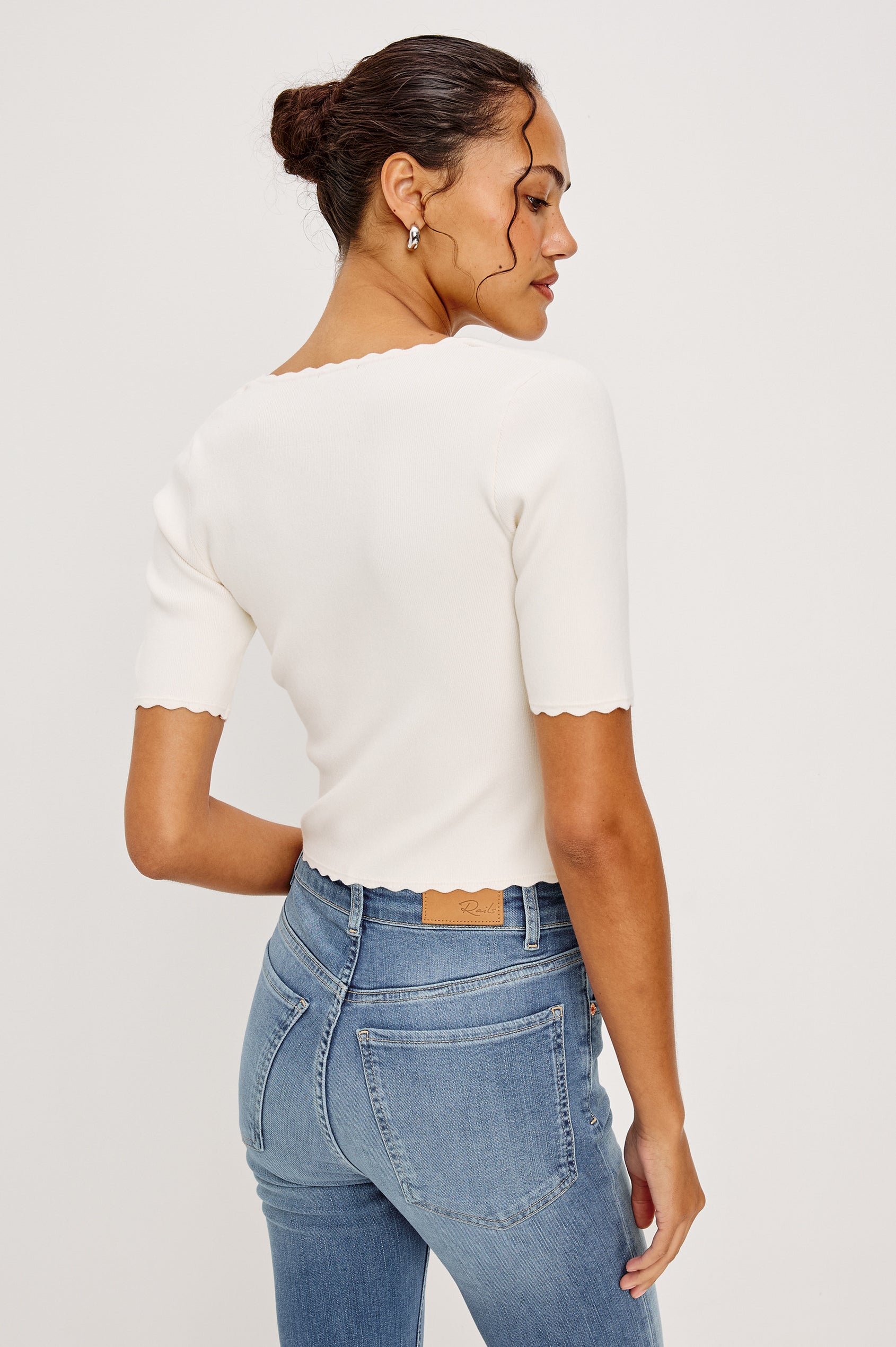 Louanna Fitted Cropped Top in Compact Knit With Scallop-Trimmed Scoop Neckline Short Sleeves and Hem in Ivory Colorway - Upper Body Back View Featured on Model