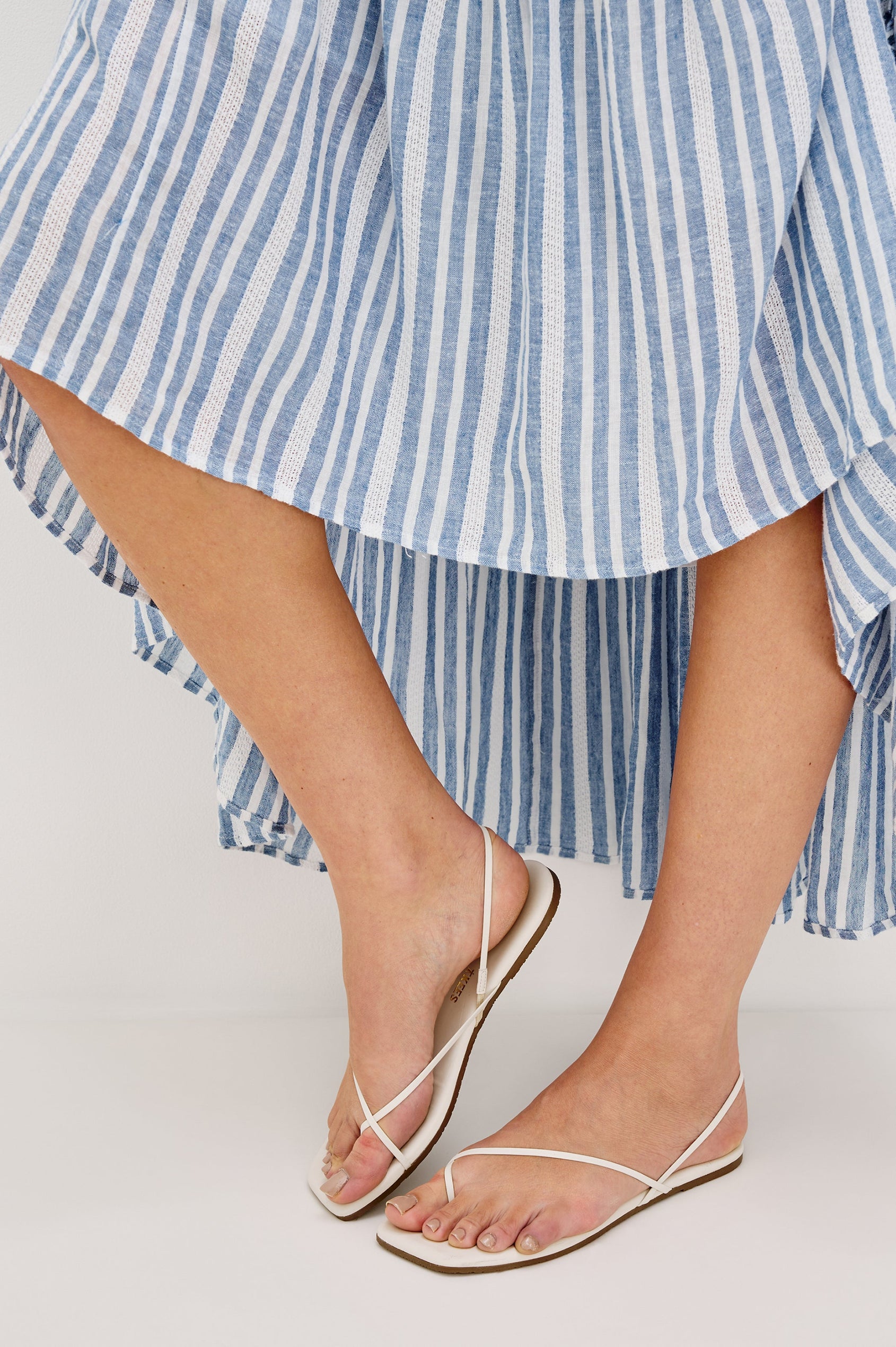 Loulou V-Neck Midi Dress with Smocked Elastic Waistband and a Multi Tiered Skirt in Blue/White Jalisco Stripe Colorway. Bottom Detail View Shown on Model.