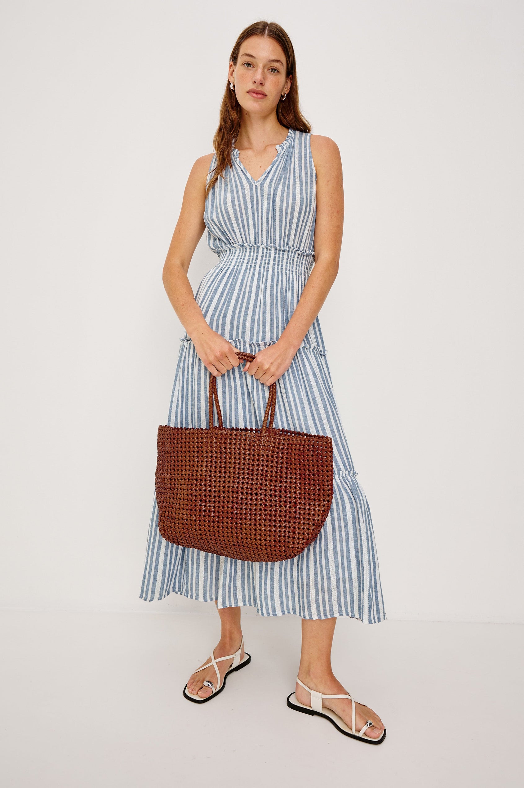 Loulou V-Neck Midi Dress with Smocked Elastic Waistband and a Multi Tiered Skirt in Blue/White Jalisco Stripe Colorway. Full Body Front View Shown on Model.