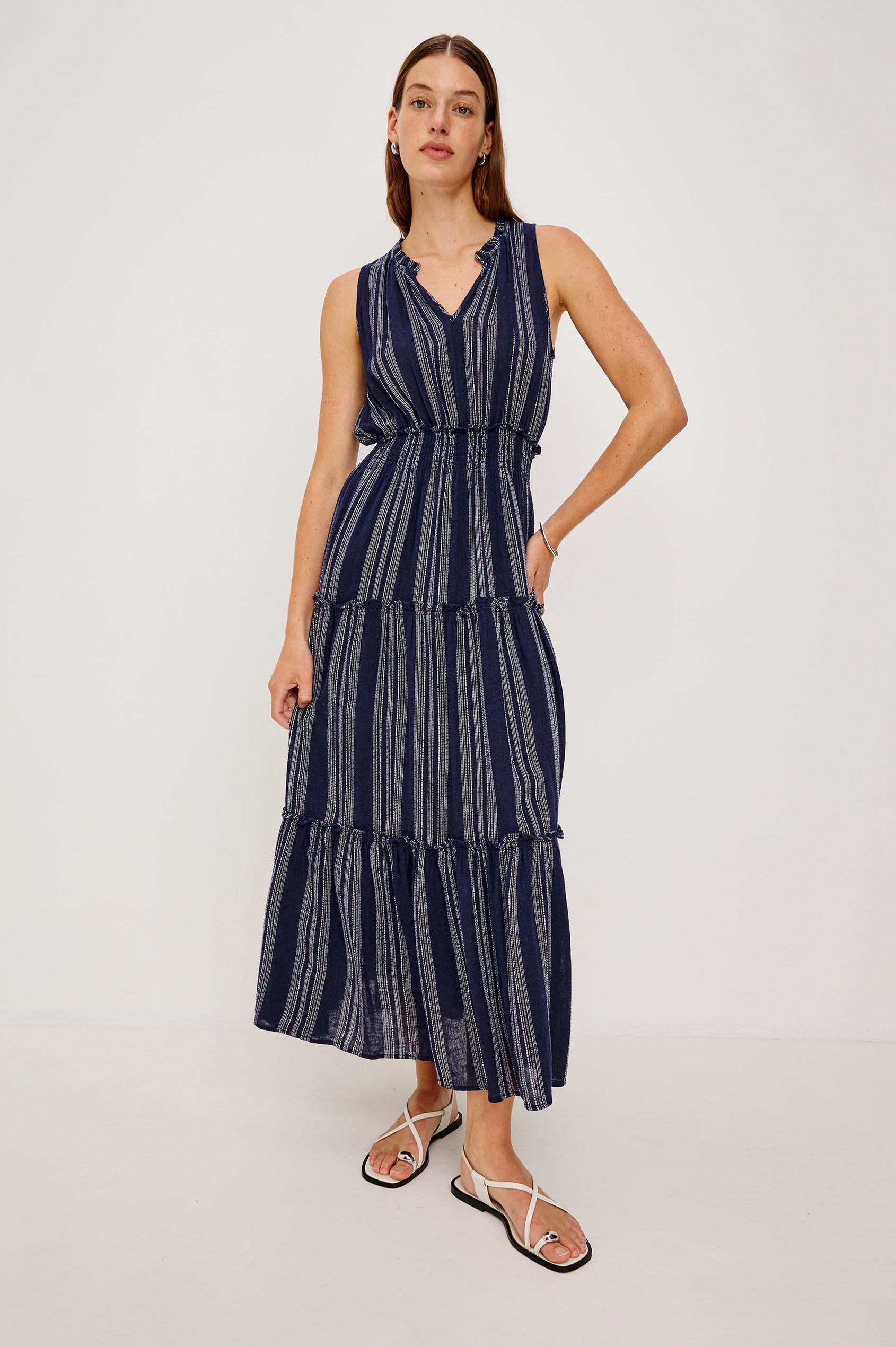 Loulou V-Neck Midi Dress with Smocked Elastic Waistband and a Multi Tiered Skirt in navy blue Magalia Stripe Colorway. Full body front view featured on model