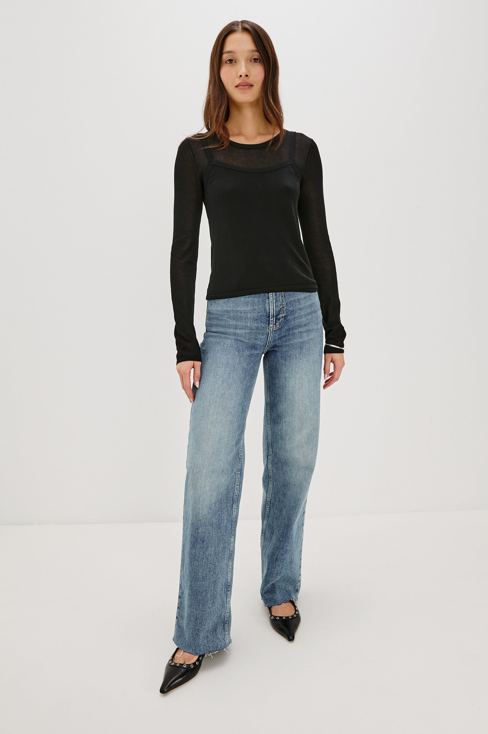 Lovisa is a cotton top designed with a layered look, featuring a lightweight tank underneath a long-sleeve crewneck in Black Colorway. The tonal pairing creates built-in dimension with a casual, modern feel. Full Body Front View featured on model.