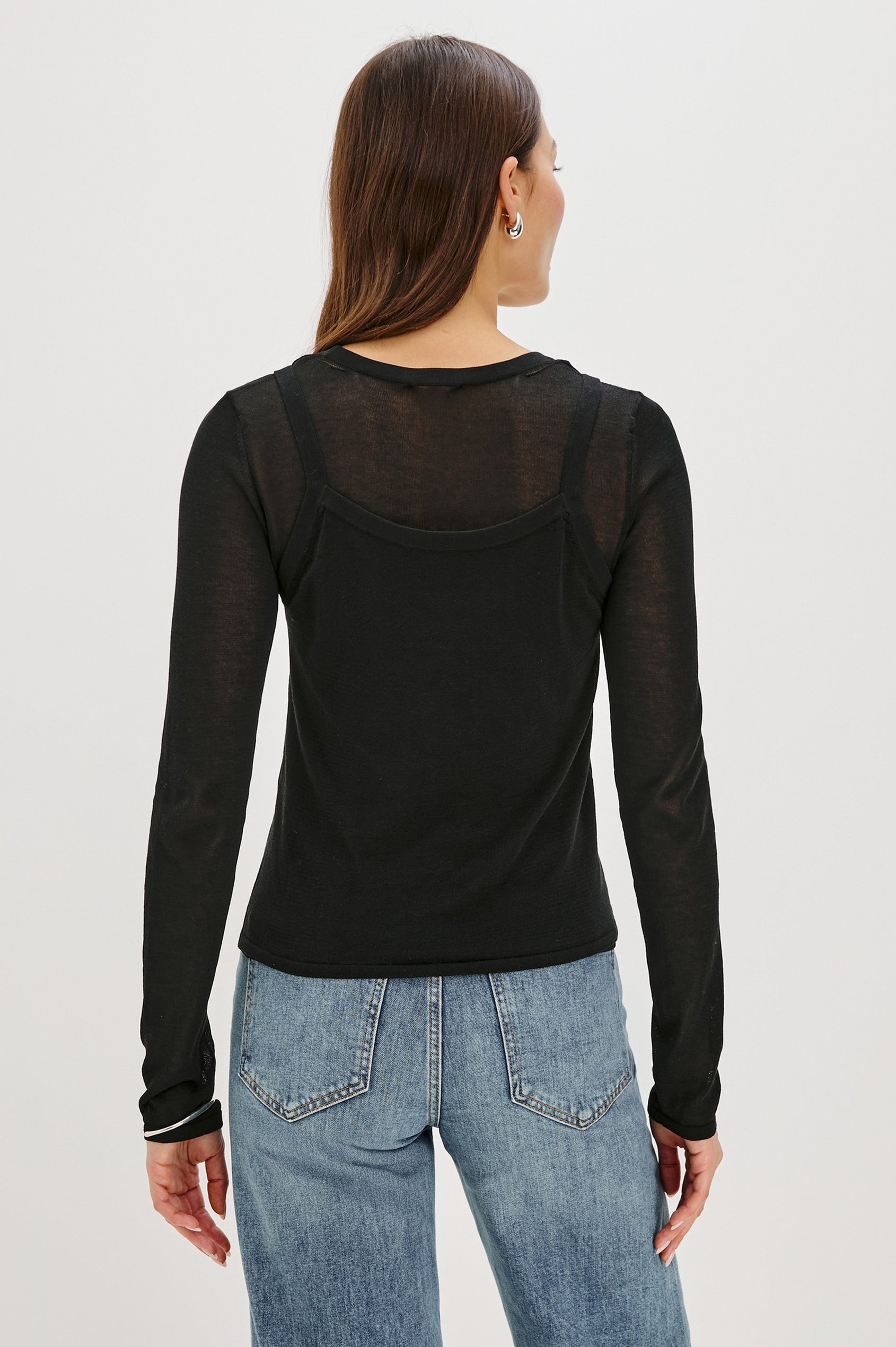 Lovisa is a cotton top designed with a layered look, featuring a lightweight tank underneath a long-sleeve crewneck in Black Colorway. The tonal pairing creates built-in dimension with a casual, modern feel. Front View featured on model.