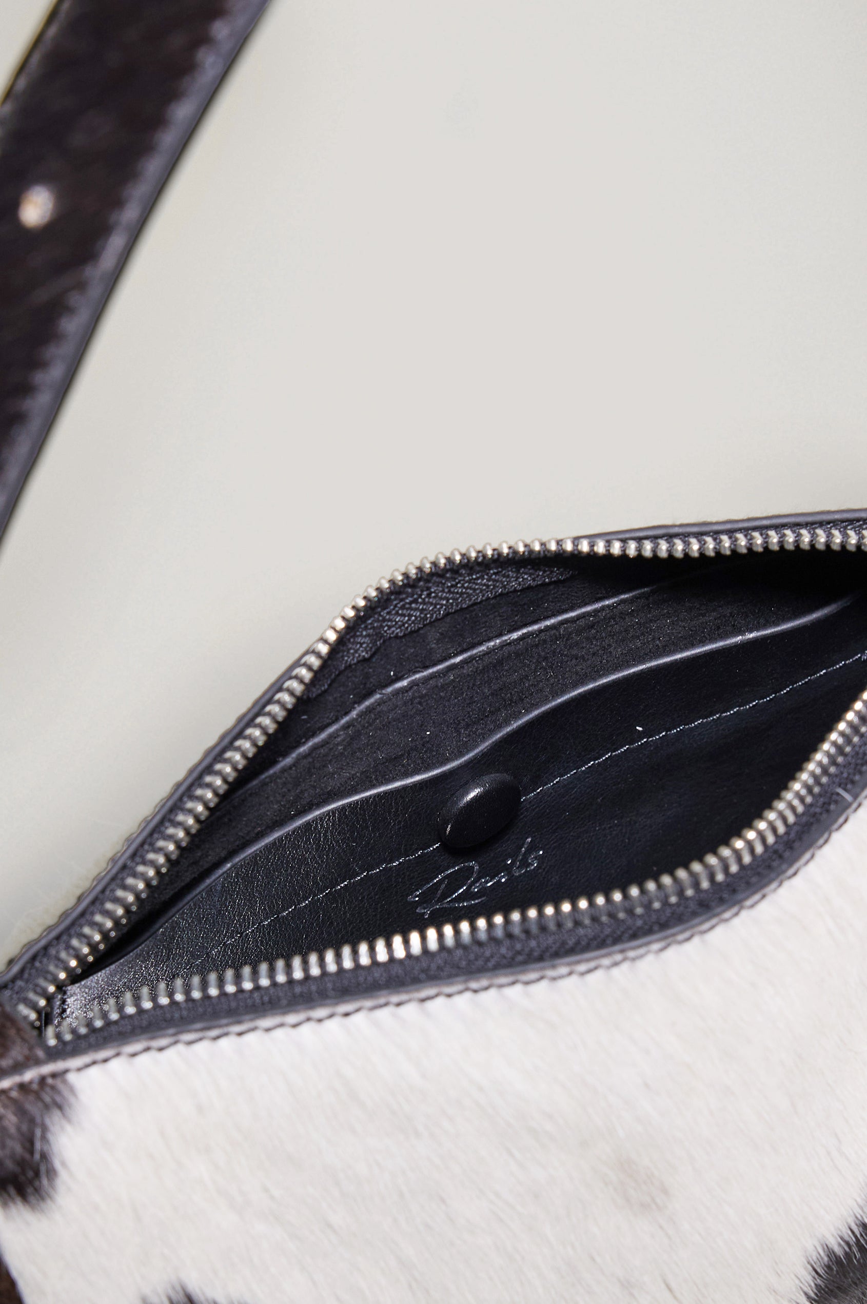 Lucca Shoulder Bag in Calfhair With Adjustable Strap and Polished Silver Buckle, Microsuede Lining, and Snap Button Interior Slip Pocket in Cowgirl Haircalf Colorway - Top Close Up View Featured