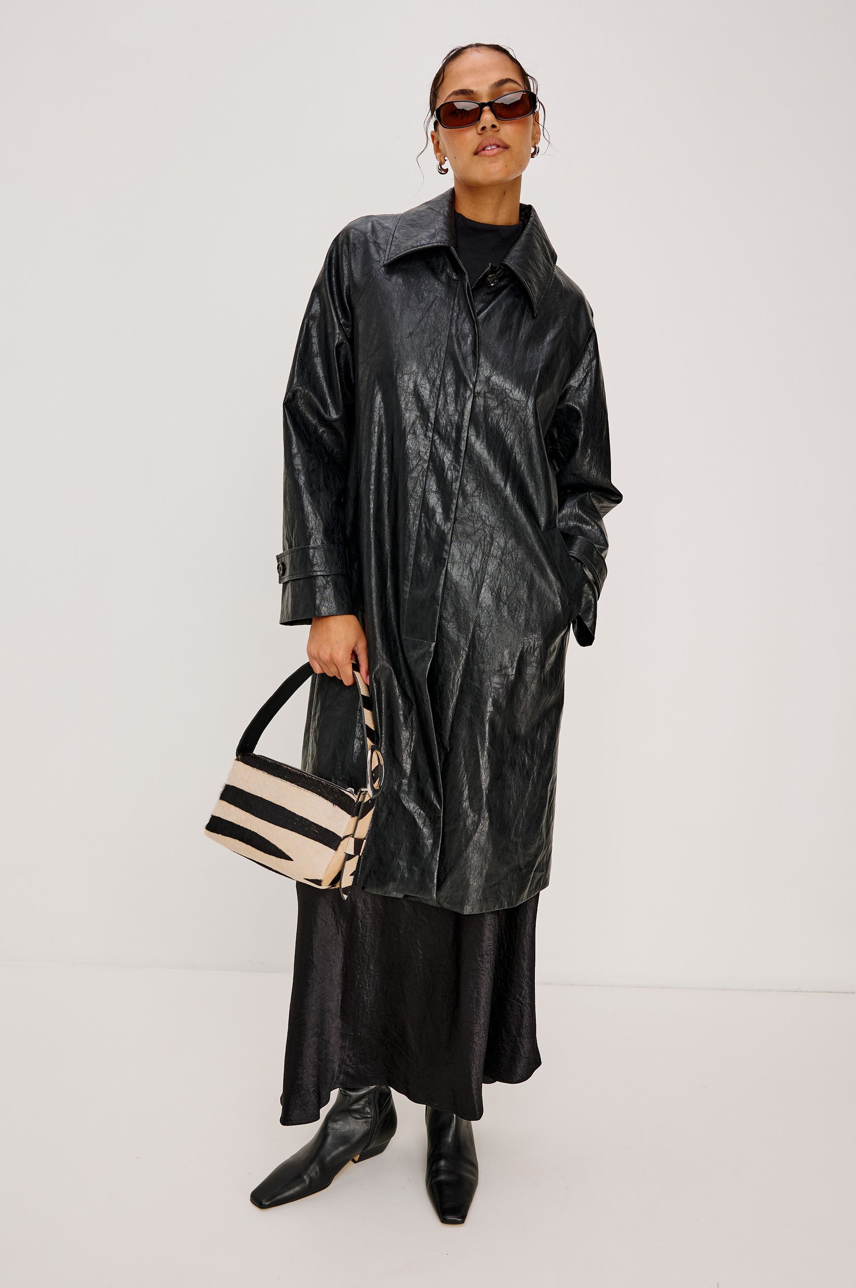 Lucca Shoulder Bag in Calfhair With Adjustable Strap and Polished Silver Buckle, Microsuede Lining, and Snap Button Interior Slip Pocket in Zebra Haircalf Colorway - Stylized on Model View Featured