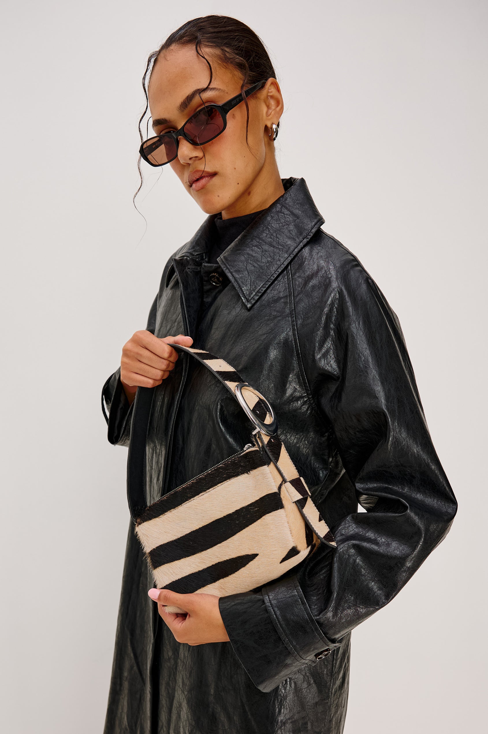 Lucca Shoulder Bag in Calfhair With Adjustable Strap and Polished Silver Buckle, Microsuede Lining, and Snap Button Interior Slip Pocket in Zebra Haircalf Colorway - Stylized on Model View Featured