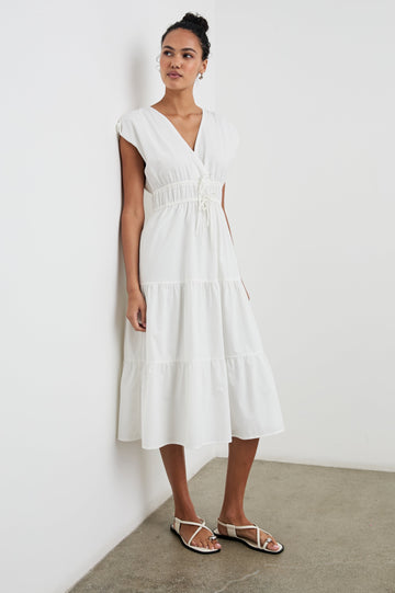 Lucia Midi Dress with Cap Sleeves, a Crossover V neckline, an Elastic Waist with Ties, and a Tiered Skirt in White Colorway - Front Full Body View Featured on Model