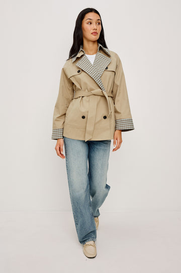Lucien Trench Jacket in Garbardine With Notched Lapels, Wide 3/4 Sleeves, Double Breasted Buttons, Adjustable Belt, and Contrast Lining in Sand - Full Body Front View Featured on Model