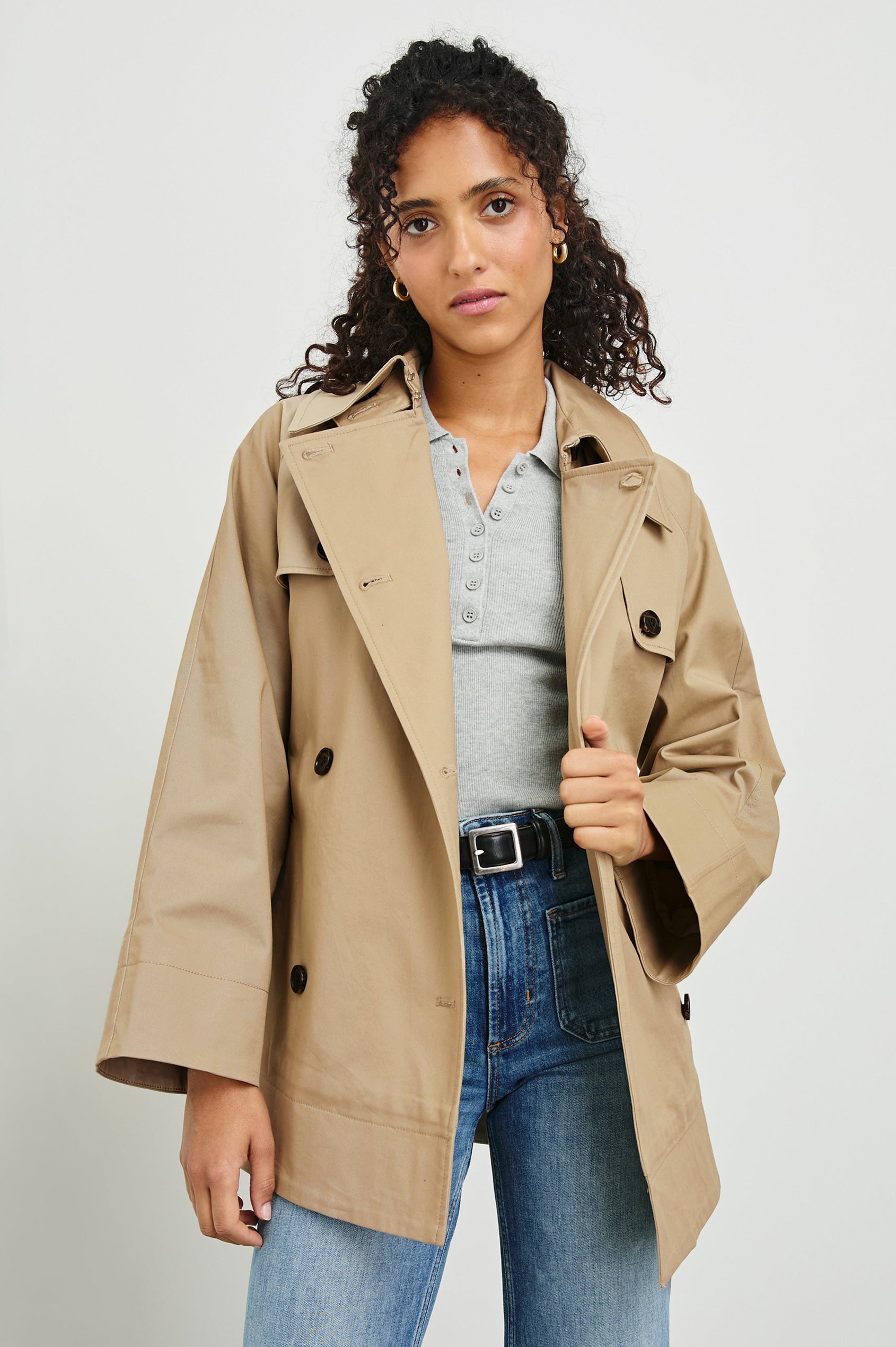 Lucien Trench Jacket with a Belt at the Waist, Button Closure and Two Front Pockets in Taupe Colorway with Dark Brown Buttons - Front View Featured on Model