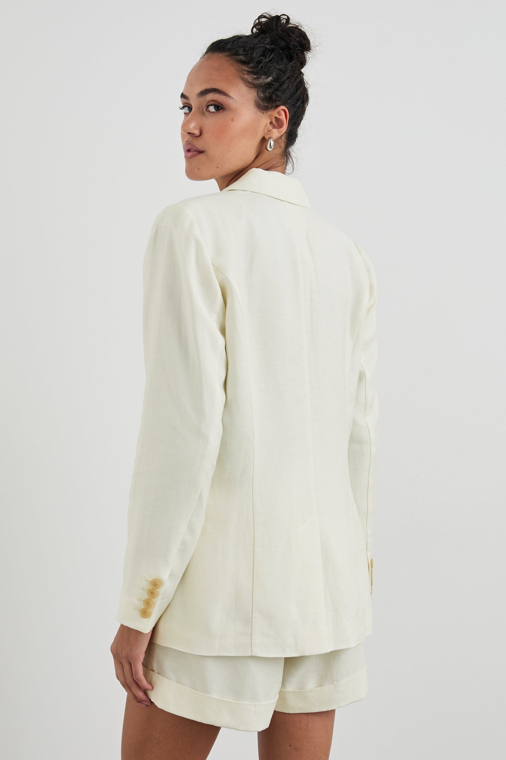 Lucienne Jacket with Two Button Closure, Two Front Flap Pockets, Four-Button Cuffs and Notched Lapels in Lotus Colorway - Back View Featured on Model  