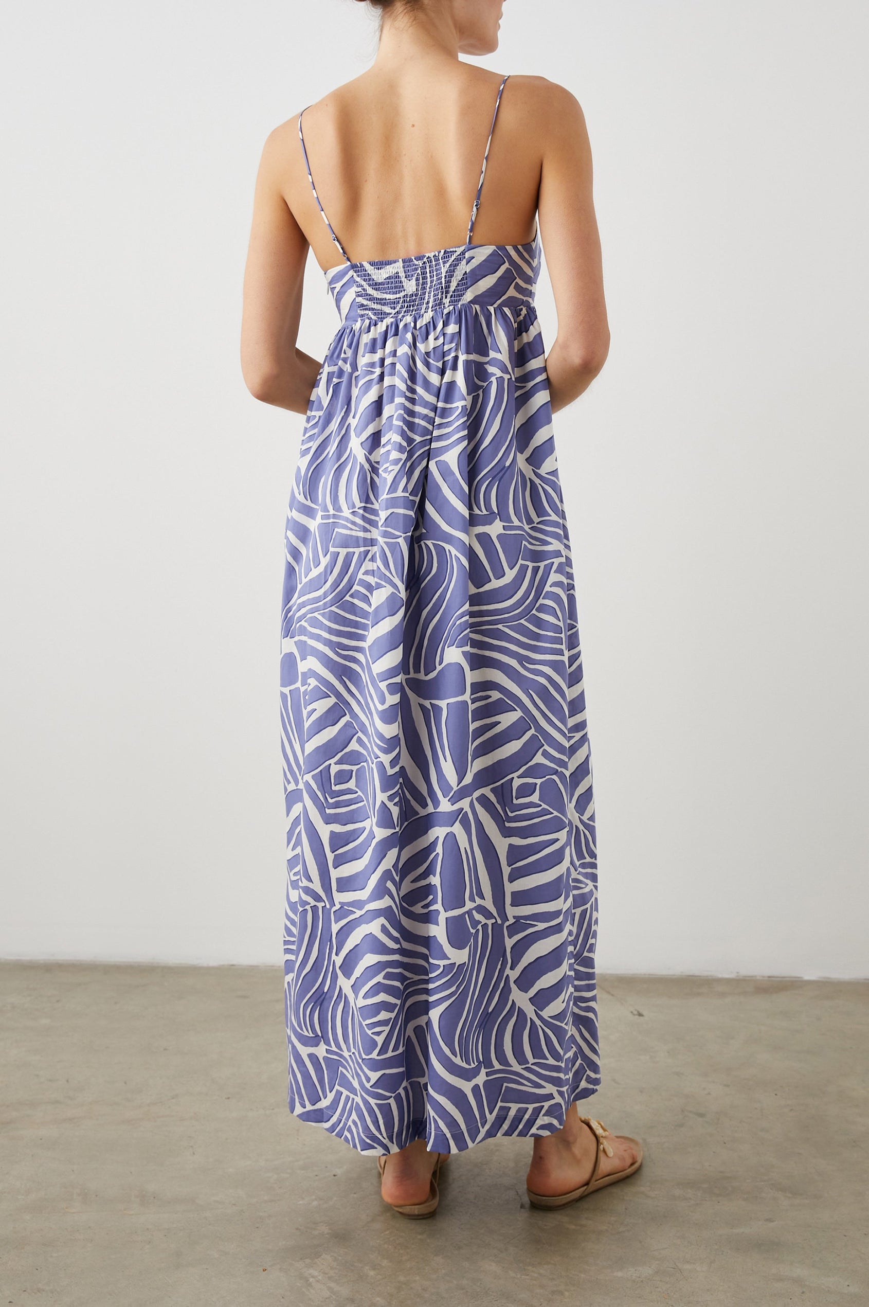 Lucille Sleeveless Maxi Dress with Adjustable Spaghetti Straps, a Square Neckline, and Shirring at the Back in Island Waves Colorway, a Purple and White Print - Back Full Body View Featured on Model  