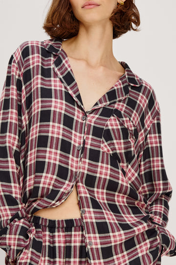 Luna Pajama Set in Signature Rayon With Button-Up Collared Shirt With Front Buttons, Long Sleeves, Chest Patch Pocket and Matching Pant With Side Pockets and Drawstring Waist Ties in Onyx Plum Plaid Colorway - Upper Body Close Up View Featured on Model