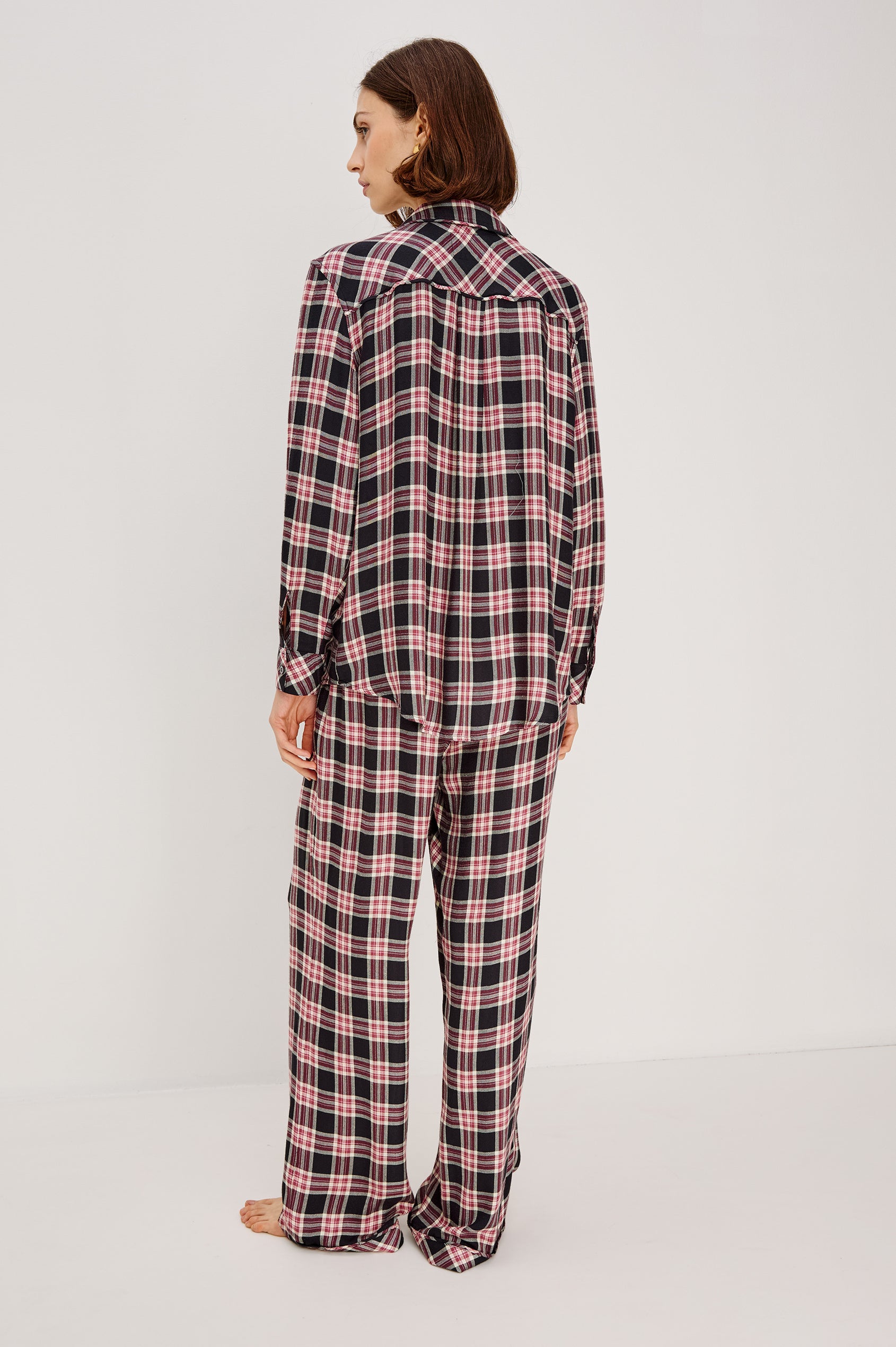Luna Pajama Set in Signature Rayon With Button-Up Collared Shirt With Front Buttons, Long Sleeves, Chest Patch Pocket and Matching Pant With Side Pockets and Drawstring Waist Ties in Onyx Plum Plaid Colorway - Full Body Back View Featured on Model