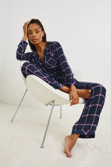 Luna Pajama Set with a Long Sleeve, Button Up, V Neck Top with a Chest Patch Pocket and Pants with Two Front Pockets in Sapphire Magenta Colorway, a plaid - Front Full Body View Featured on Seated Model  