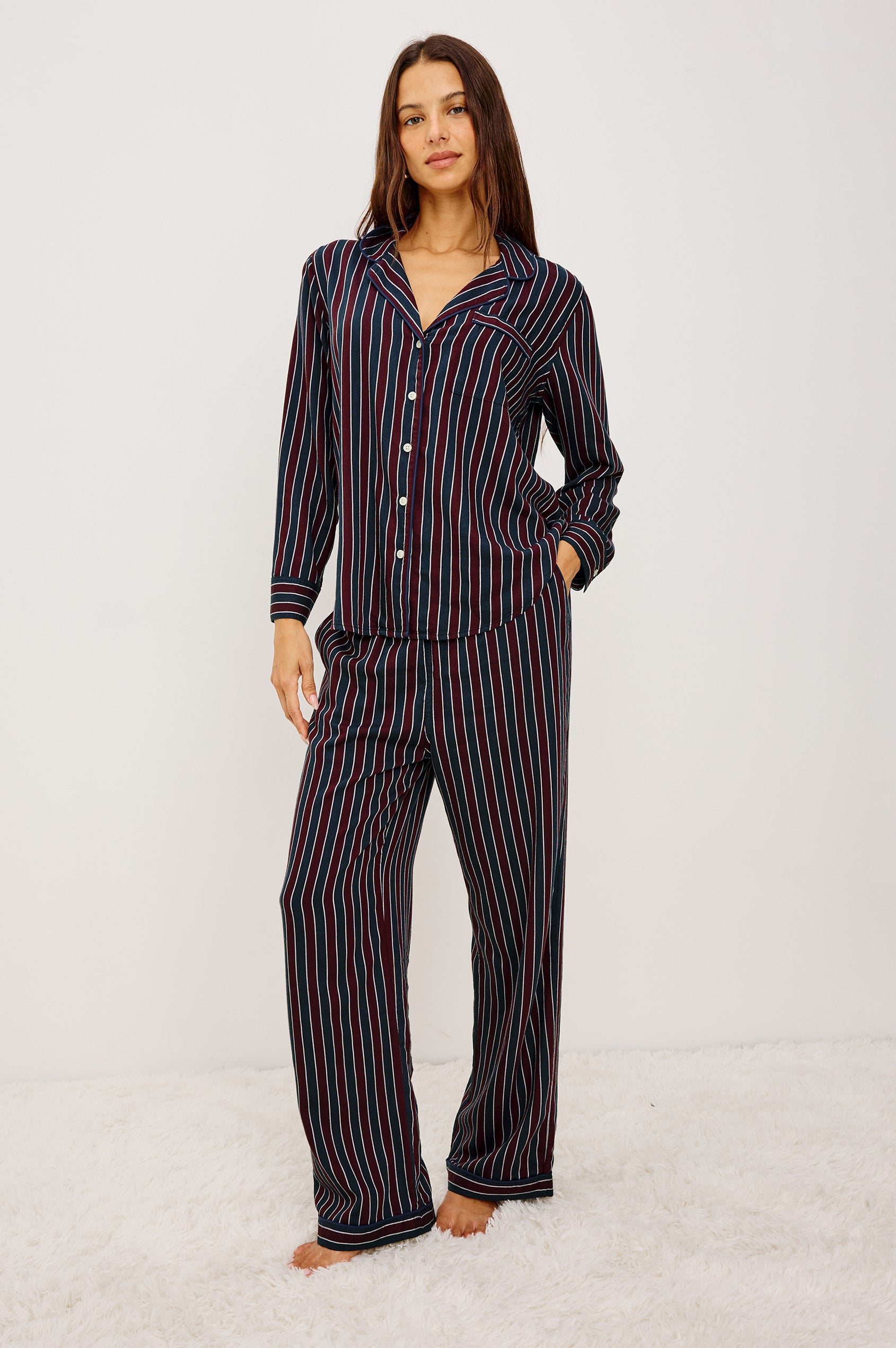 Luna Pajama Set in Signature Rayon With Button-Up Collared Shirt With Front Buttons, Long Sleeves, Chest Patch Pocket and Matching Pant With Side Pockets and Drawstring Waist Ties in Navy Oxblood Stripe Colorway - Full Body Front View Featured on Model