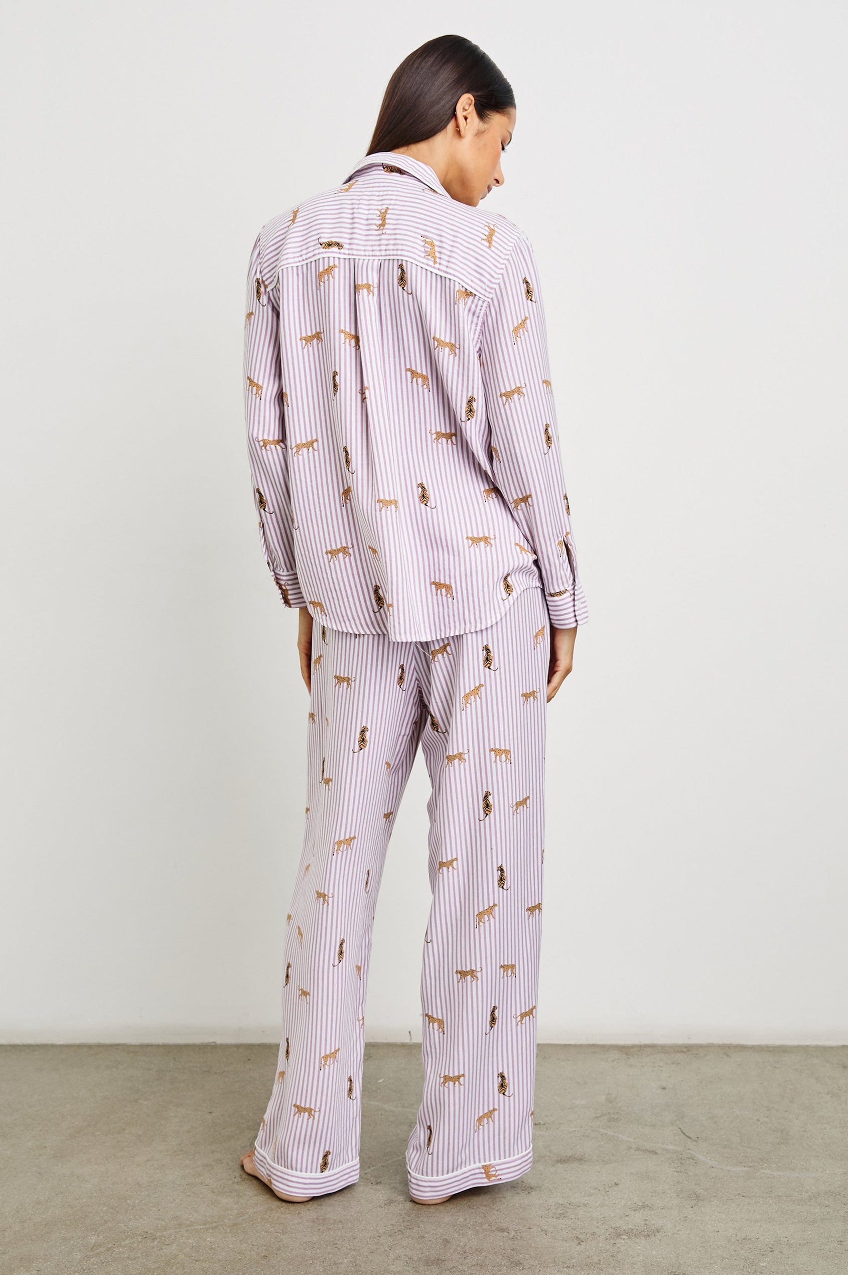 Luna Pajama Set with a Long Sleeve, Button Up, V Neck Top with a Chest Patch Pocket and Pants with Two Front Pockets in Rose Stripe Cats Colorway, Gold Wildcats on Rose and White Vertical Stripes - Back Full Body View Featured on Model  