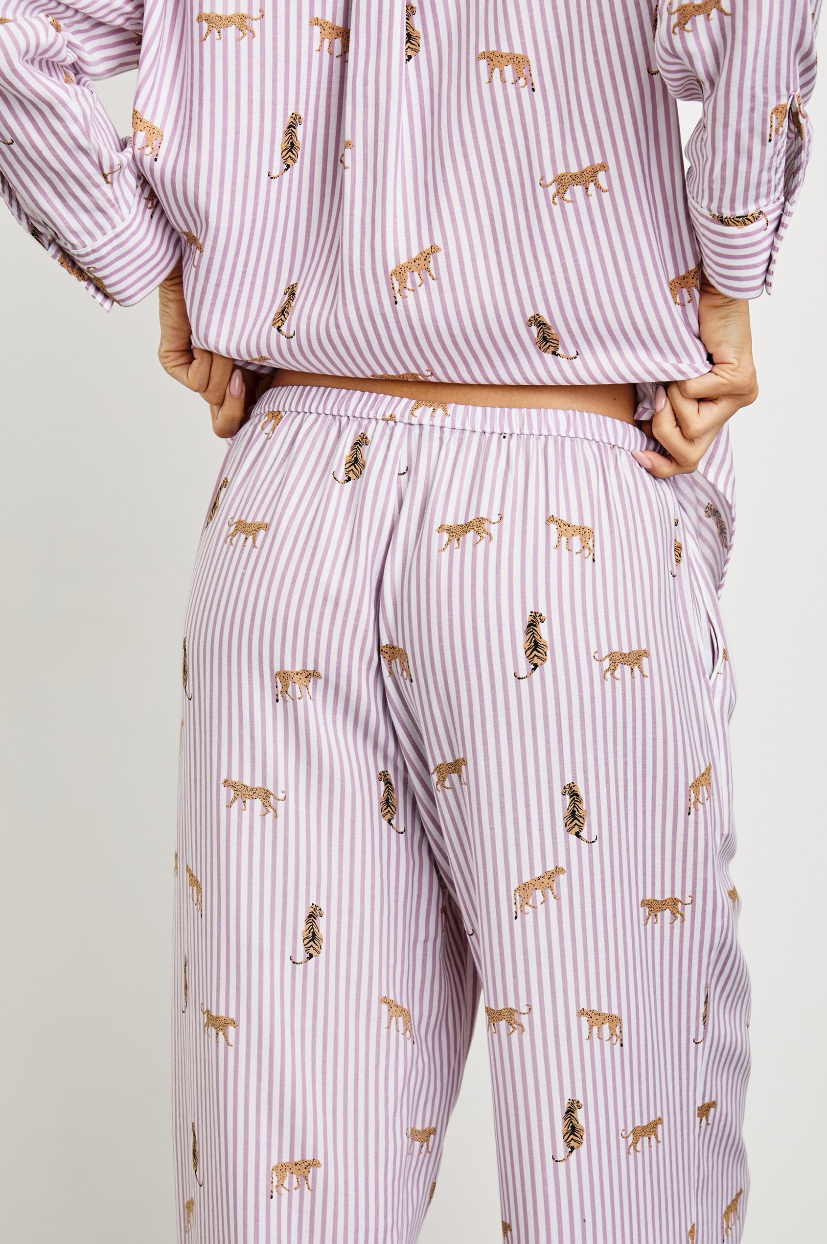 Luna Pajama Set with a Long Sleeve, Button Up, V Neck Top with a Chest Patch Pocket and Pants with Two Front Pockets in Rose Stripe Cats Colorway, Gold Wildcats on Rose and White Vertical Stripes - Back View Featured on Model  