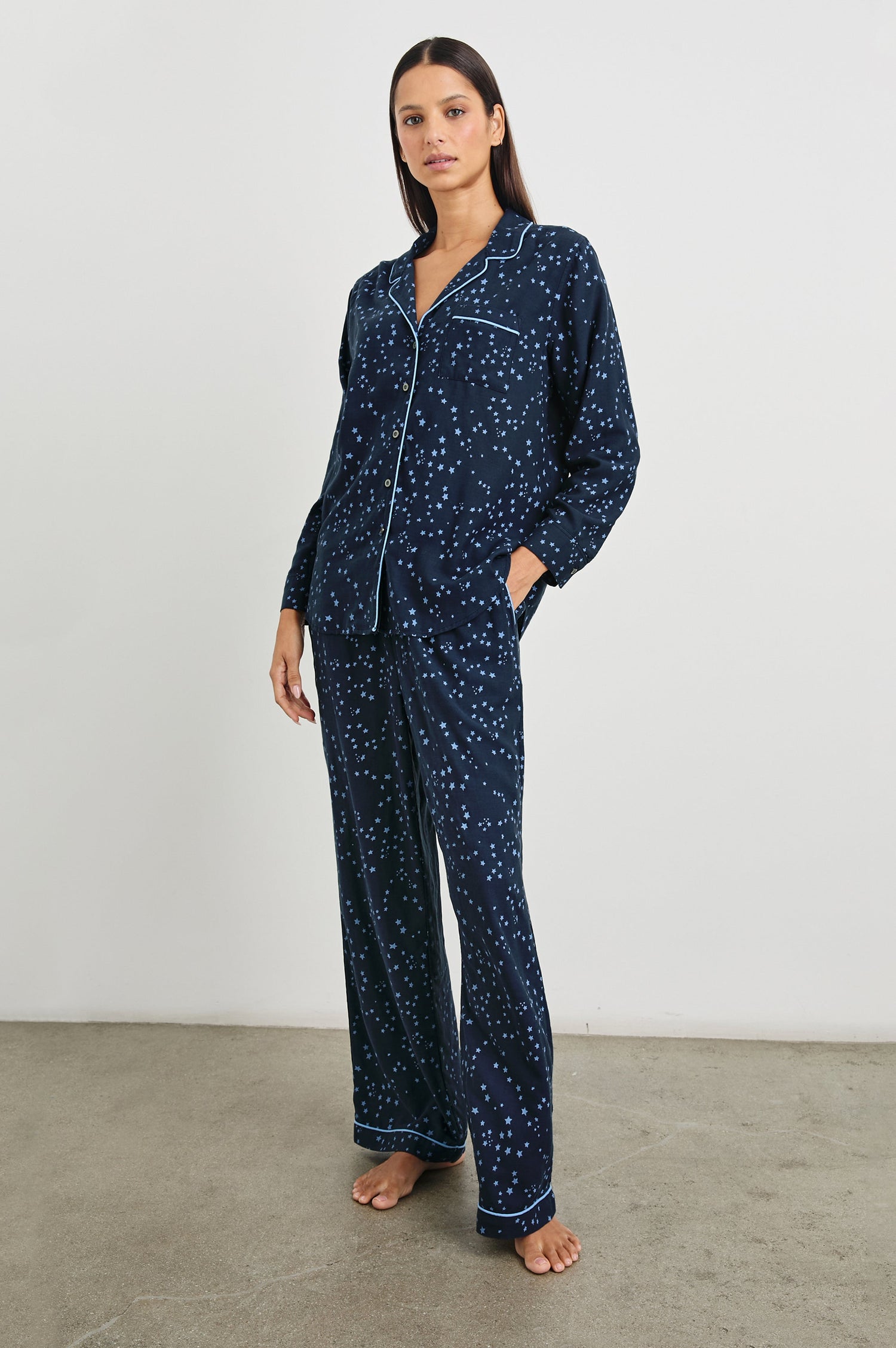 Luna Pajama Set with a Long Sleeve, Button Up, V Neck Top with a Chest Patch Pocket and Pants with Two Front Pockets in Stellar Colorway, blue starts on Dark Blue - Front Full Body View Featured on Model  