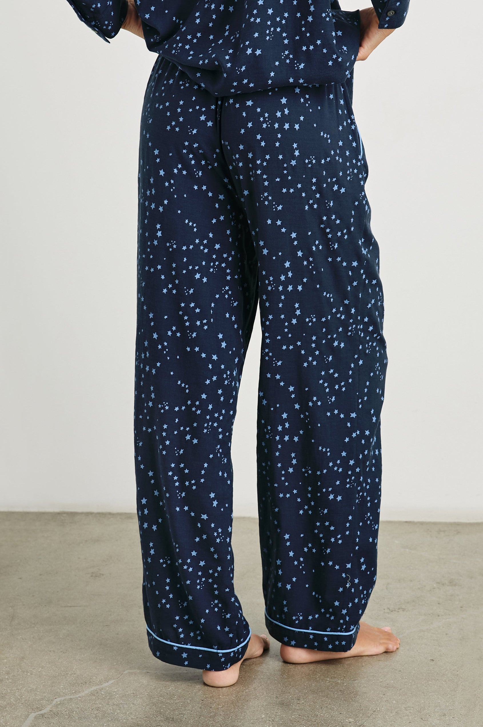 Luna Pajama Set with a Long Sleeve, Button Up, V Neck Top with a Chest Patch Pocket and Pants with Two Front Pockets in Stellar Colorway, blue starts on Dark Blue - Back View Featured on Model  