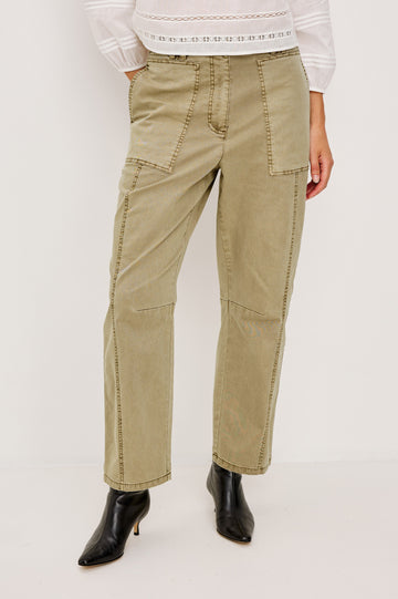 Mid-rise, barrel-leg pants made from stretch twill in Light Olive colorway. The pants have knee seaming, front pockets, a zip fly, and an adjustable drawstring waist for a casual, comfortable fit. Front view featured on model.