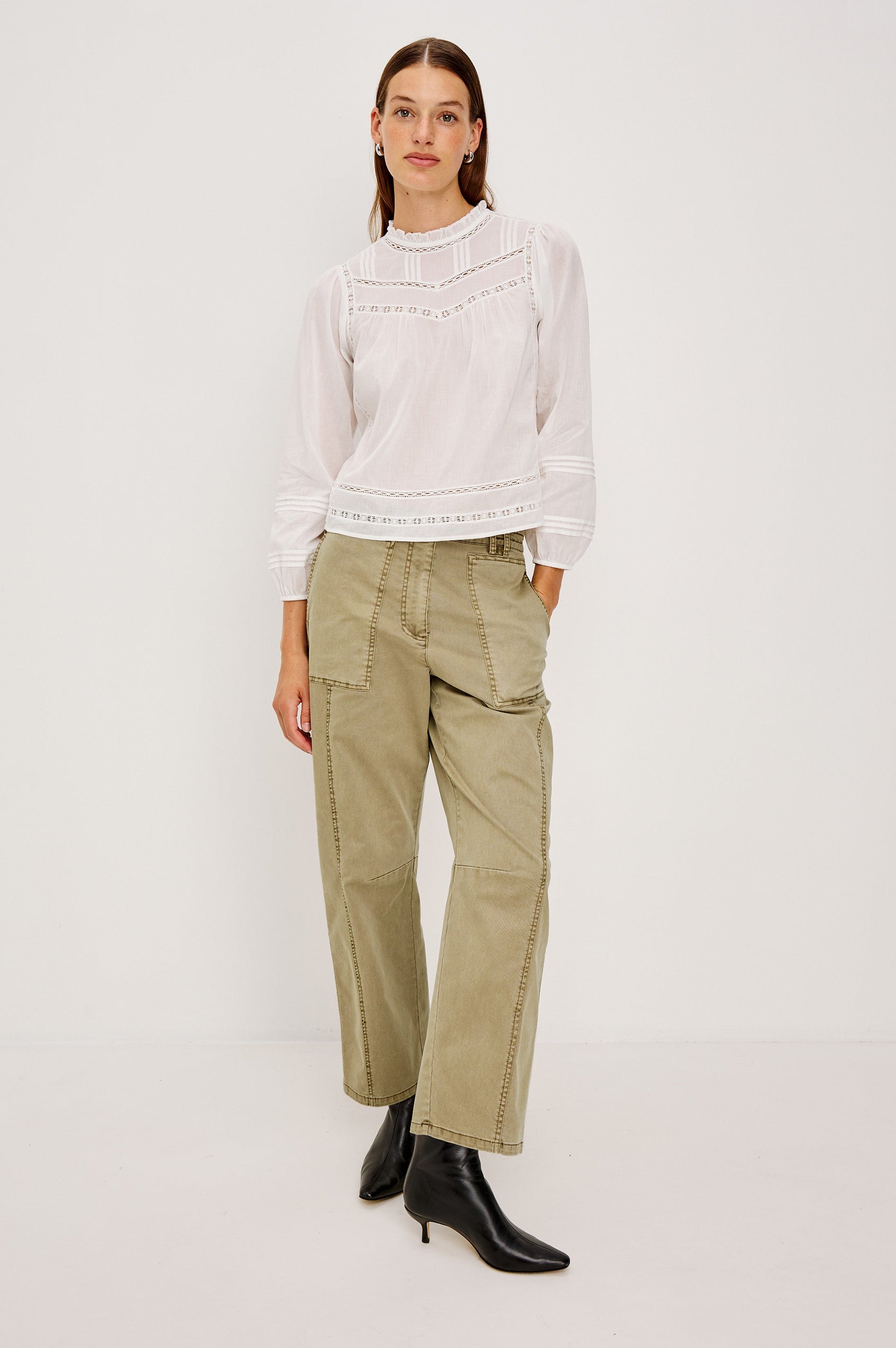 Mid-rise, barrel-leg pants made from stretch twill in Light Olive colorway. The pants have knee seaming, front pockets, a zip fly, and an adjustable drawstring waist for a casual, comfortable fit. Full body front view featured on model.