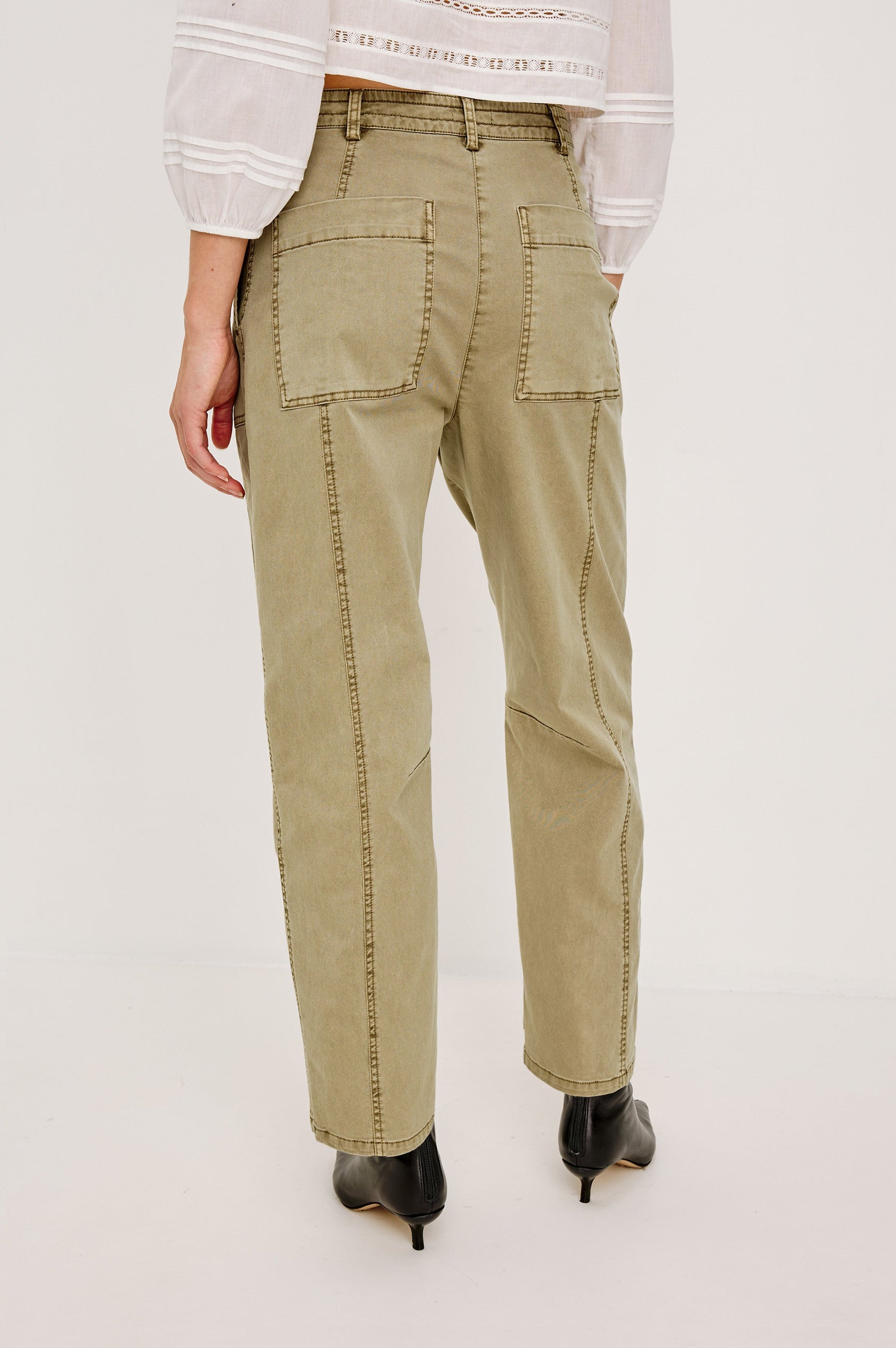 Mid-rise, barrel-leg pants made from stretch twill in Light Olive colorway. The pants have knee seaming, front pockets, a zip fly, and an adjustable drawstring waist for a casual, comfortable fit. Back view featured on model.
