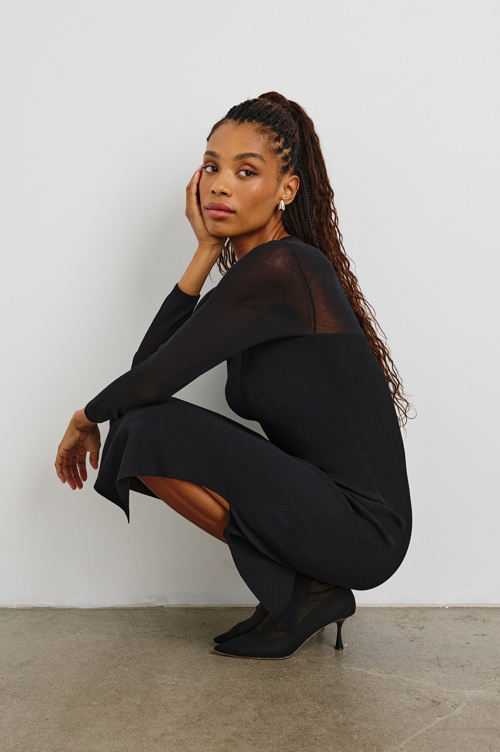 Luz Long-Sleeve Midi Dress with Transparent Yoke and Sleeves and Mid-Thigh Side Slit in Black Colorway - Side Full Body View Featured on Crouching Model