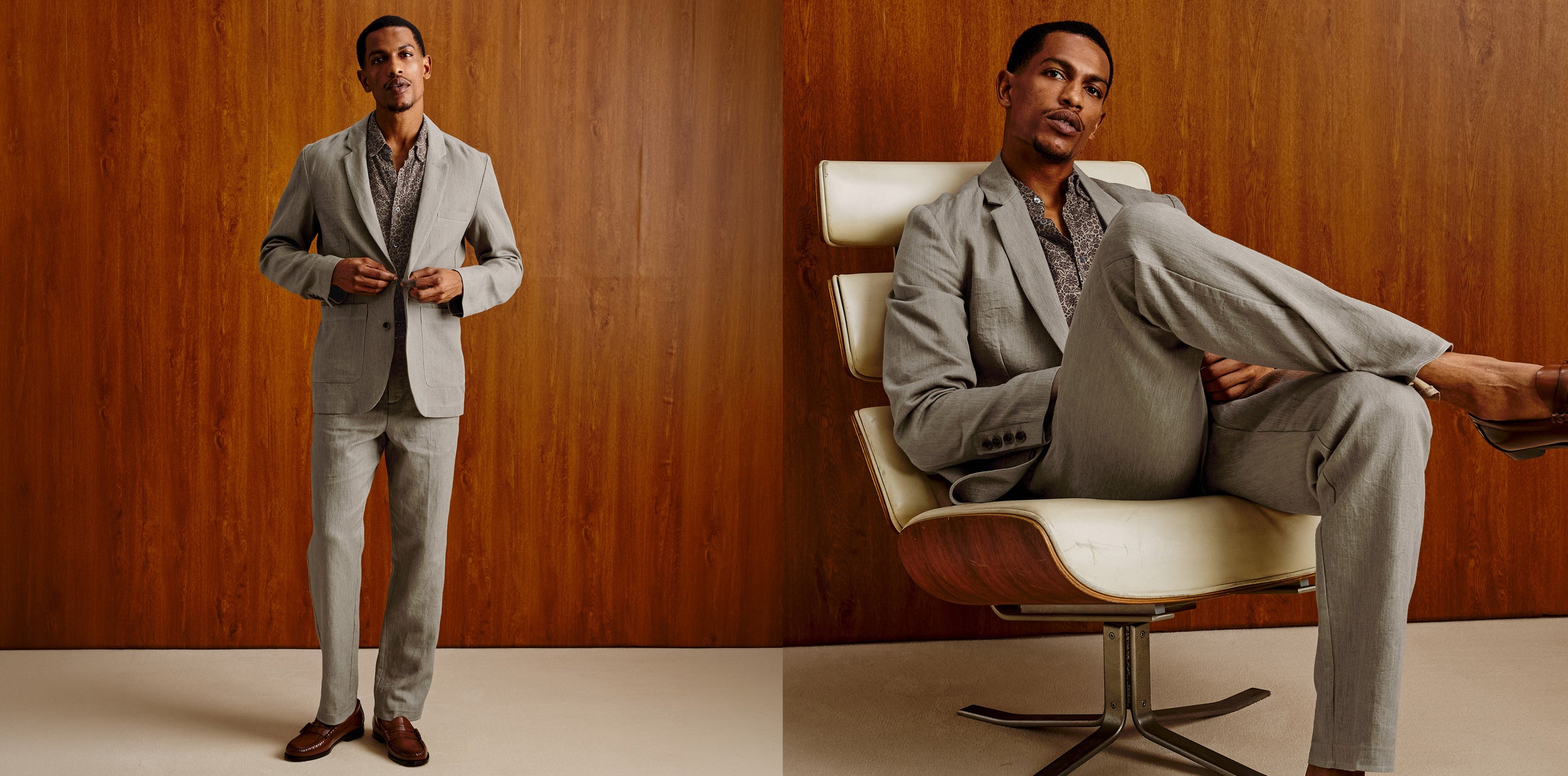 A man modeling a light gray two-piece suit in two studio poses against a wood-paneled background. The left side shows him standing and buttoning the jacket, and the right side shows him seated in a cream lounge chair with one leg crossed over the other.
