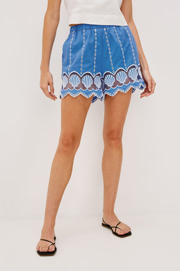 Mai Pull On Short with Elastic Waist, Embroidery and Scalloped Hem in French Blue Colorway. Front View Shown on Model.