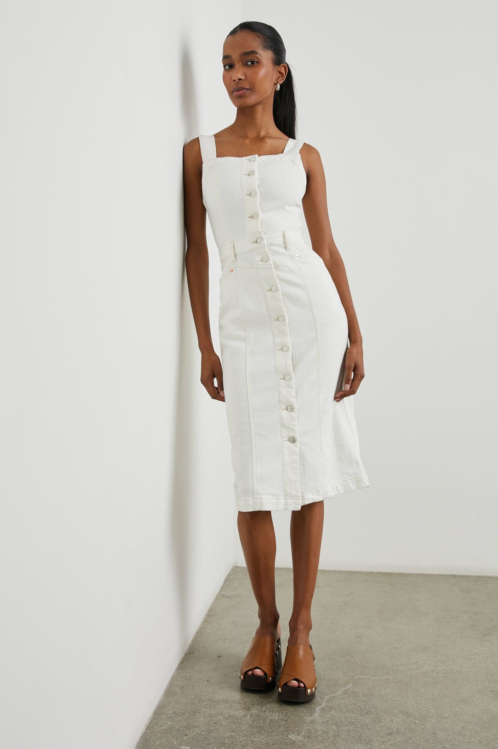 Malibu Sleeveless Denim Midi Dress with Shoulder Straps, Buttons Down the Front, a Square Neckline in the Front and Back, Two Front Pockets and Two Back Patch Pockets in Vintage Ecru Colorway - Front Full Body View Featured on Model
