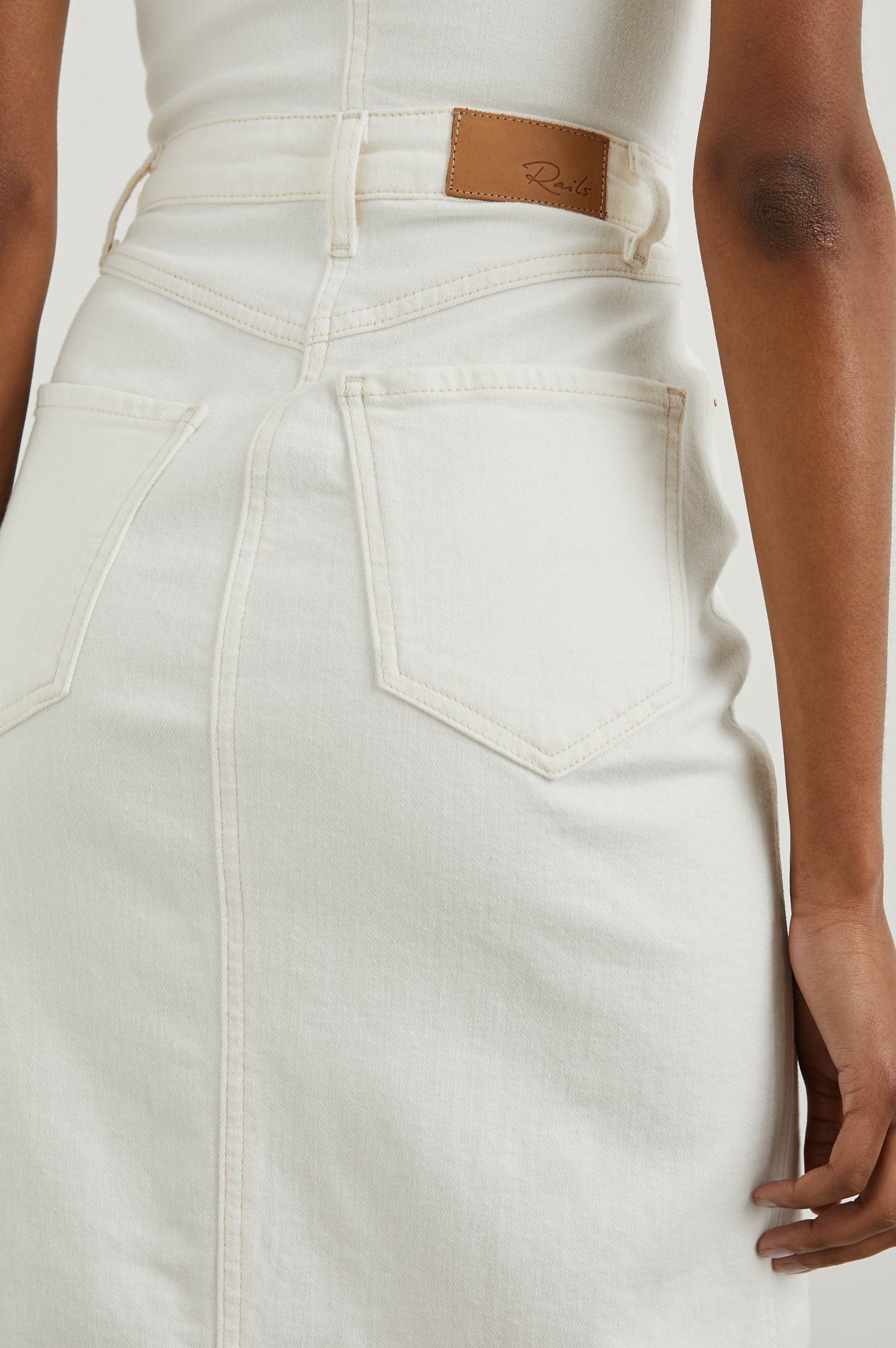 Malibu Sleeveless Denim Midi Dress with Shoulder Straps, Buttons Down the Front, a Square Neckline in the Front and Back, Two Front Pockets and Two Back Patch Pockets in Vintage Ecru Colorway - Back View Featured on Model