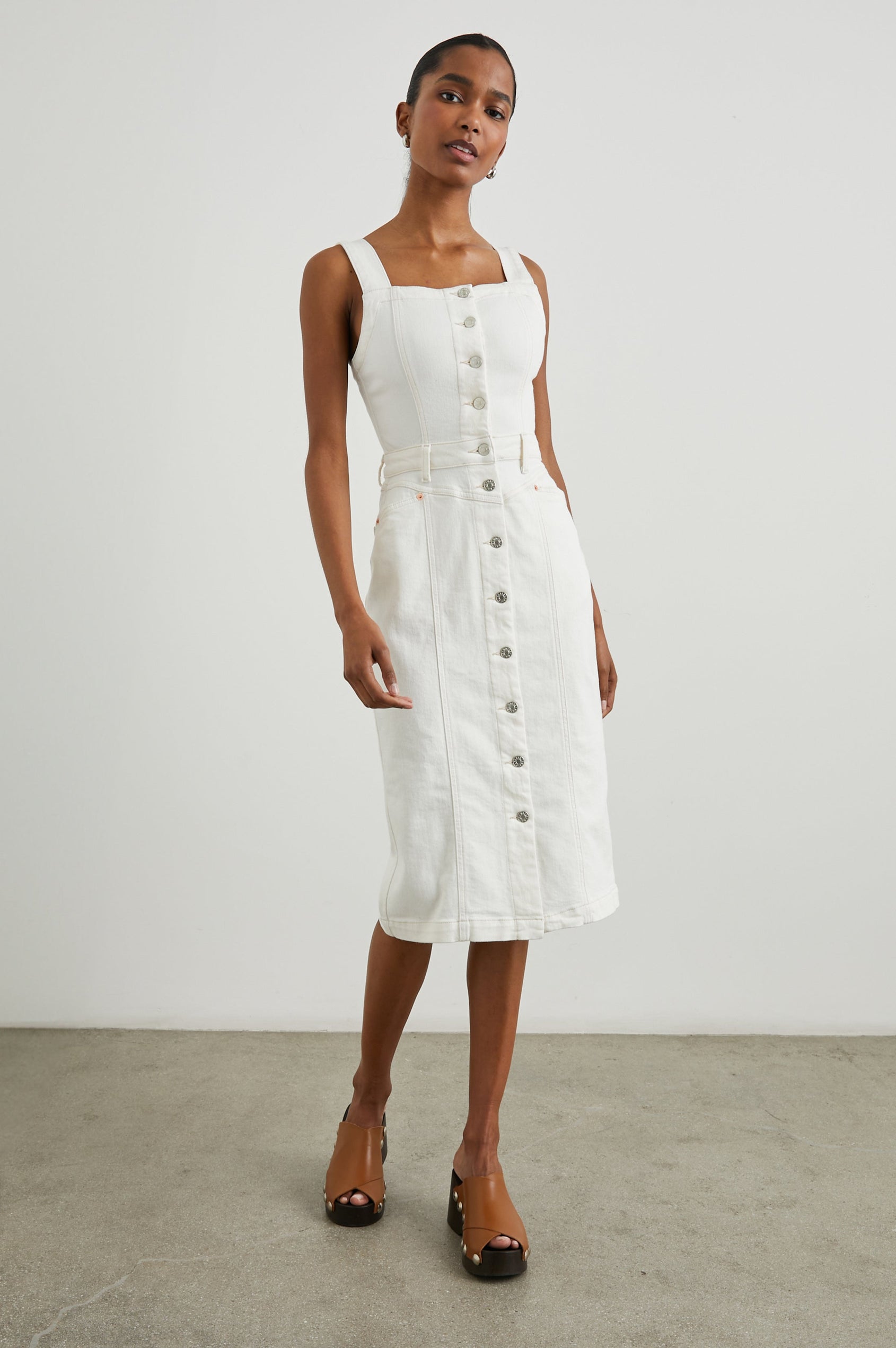 Malibu Sleeveless Denim Midi Dress with Shoulder Straps, Buttons Down the Front, a Square Neckline in the Front and Back, Two Front Pockets and Two Back Patch Pockets in Vintage Ecru Colorway - Front Full Body View Featured on Model