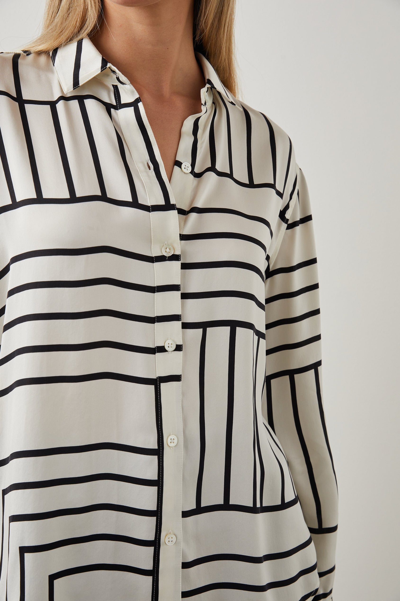 Mara Long-Sleeve Button Up with One Center Pleat Under the Back Yoke in Patchwork Stripe Colorway, Patches of Horizontal and Vertical Black Stripes on Cream - Front View Featured on Model 