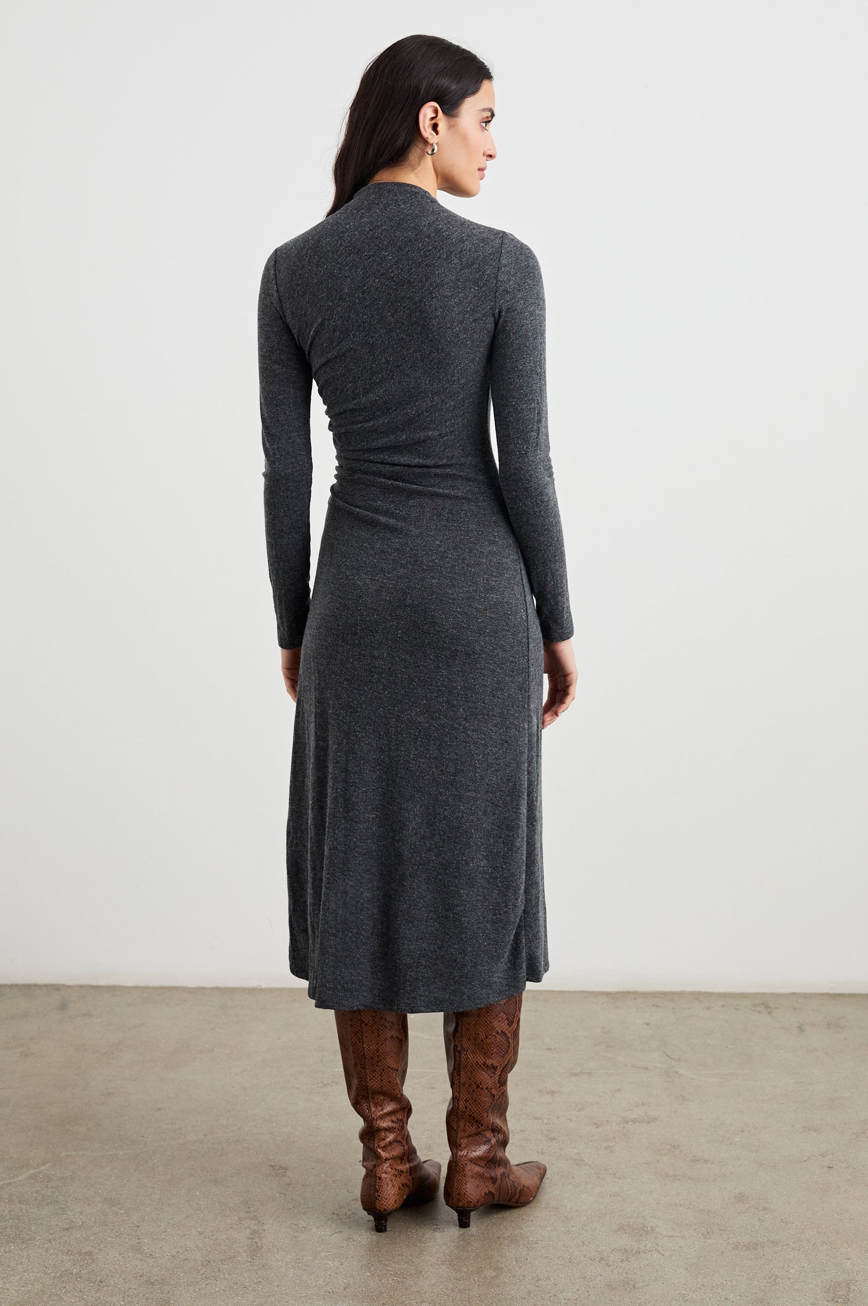 Margaret Long-Sleeve Midi Dress with a Mock Neck and Shirring along the Left Side in Charcoal Colorway - Back Full Body View Featured on Model