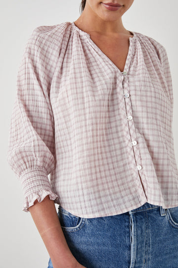 Mariah Top with Three-Quarter Sleeves, Shirred Cuffs, V-Neckline, and Buttons Down the Front in Soft Rose Check Colorway, a White and Rose Plaid - Front View Featured on Model  