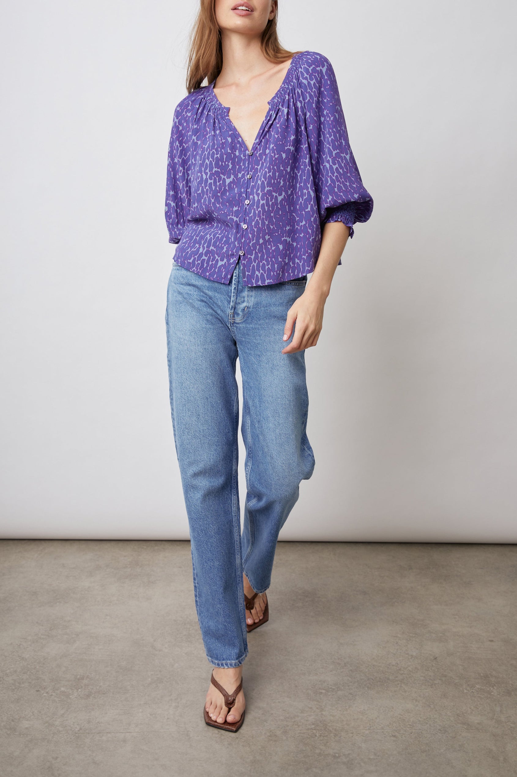 Mariah Top with Three-Quarter Sleeves, Shirred Cuffs, V-Neckline, and Buttons Down the Front in Static Leopard Print Colorway, a purple print - Front Full Body View Featured on Model  