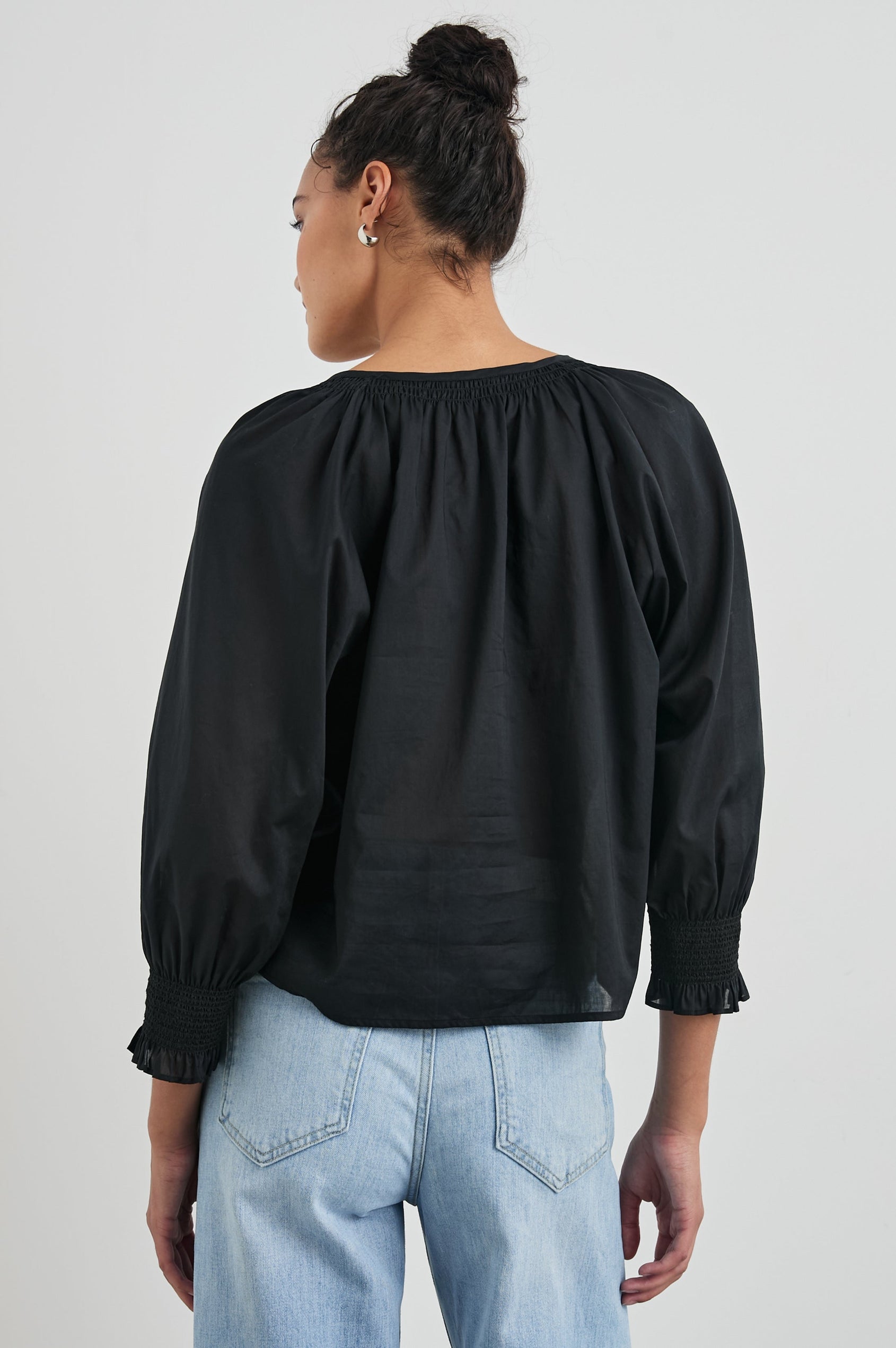 Mariah Top with Three-Quarter Sleeves, Shirred Cuffs, V-Neckline, and Buttons Down the Front in Black Colorway - Back View Featured on Model  