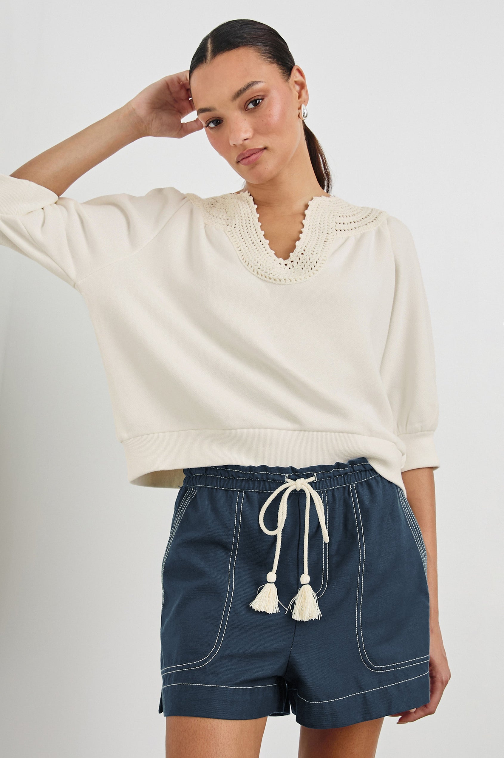 Mariposa Relaxed Fit Top with Elbow Length Sleeves, Tonal Embroidery Details Along Split Neckline in Ivory Colorway. Front View Shown on Model.