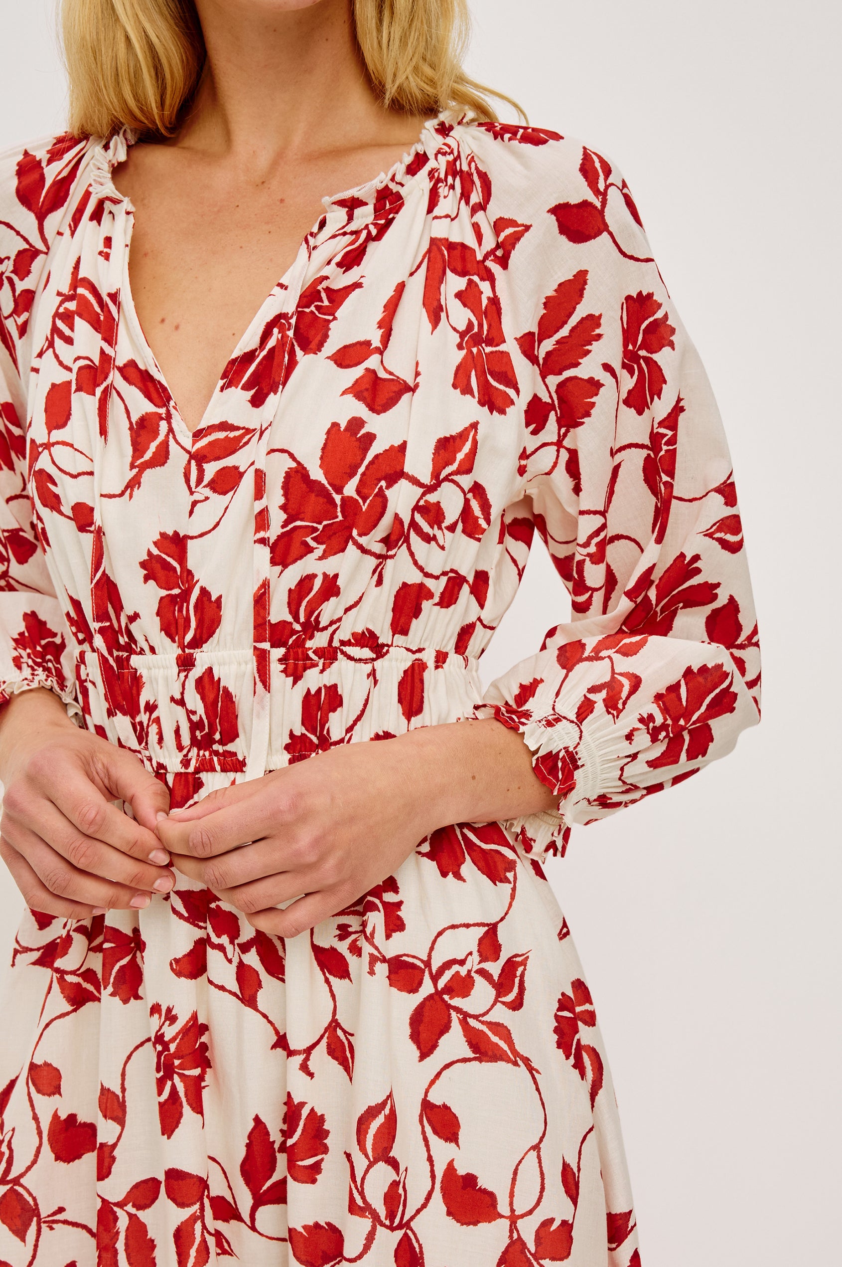 Matia Maxi Dress in Cotton With Banded Ruffle V-Neckline With Self-Ties Elastic Waist and Long Raglan Puff Sleeves in Red Jasmine Colorway - Upper Body Close Up Frontt View Featured on Model