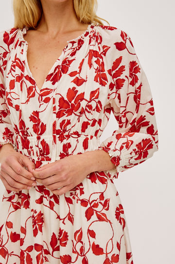 Matia Maxi Dress in Cotton With Banded Ruffle V-Neckline With Self-Ties Elastic Waist and Long Raglan Puff Sleeves in Red Jasmine Colorway - Upper Body Close Up Frontt View Featured on Model