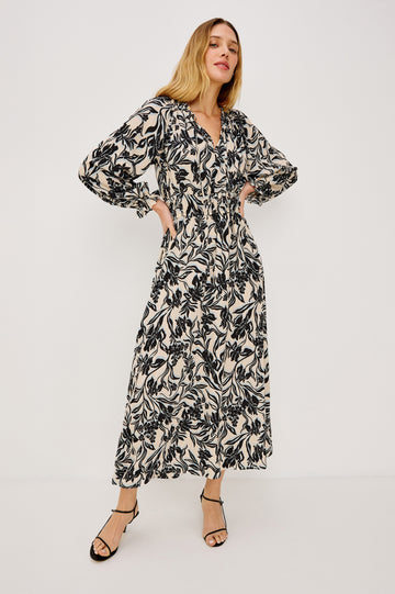 Matia Maxi Dress in Cotton With Banded Ruffle V-Neckline With Self-Ties, Elastic Waist, and Long Raglan Puff Sleeves in Zinya Colorway - Full Body Front View Featured on Model