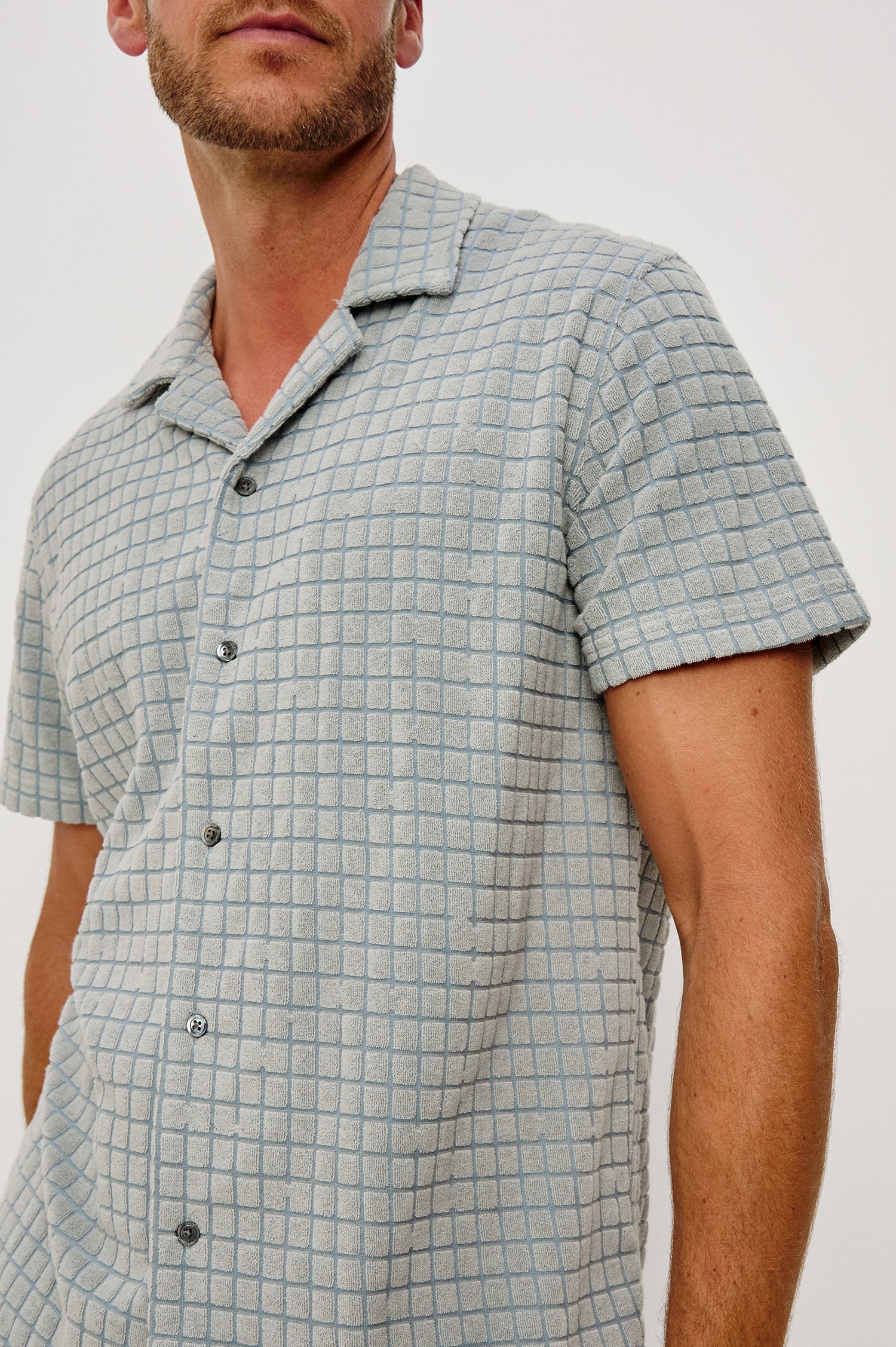 Maverick Short Sleeve Shirt in French Terry With Jacquard Pattern, Notched Collar, Front Buttons, and Classic Fit in Silver Line Blue Grid Colorway - Upper Body Close Up Front View Featured on Model