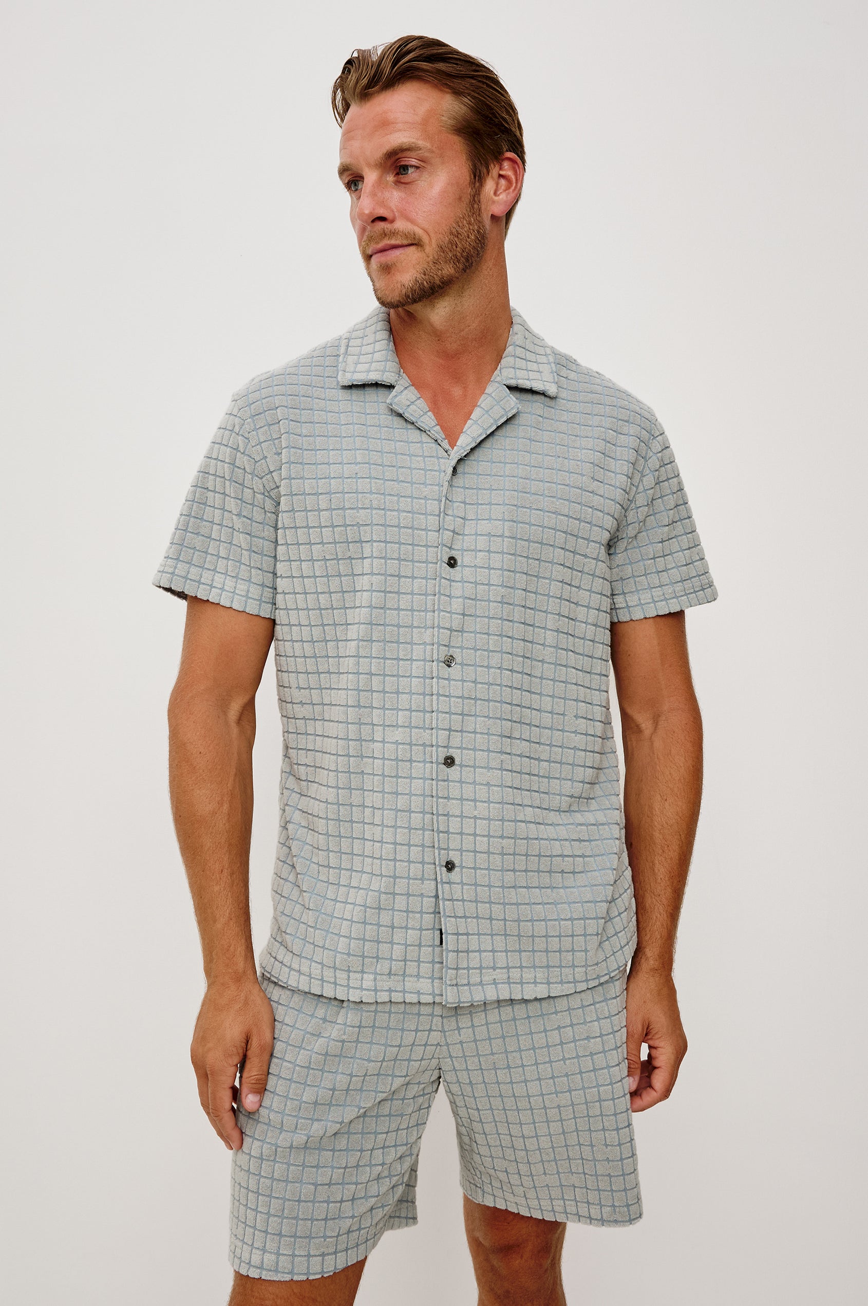 Maverick Short Sleeve Shirt in French Terry With Jacquard Pattern, Notched Collar, Front Buttons, and Classic Fit in Silver Line Blue Grid Colorway - Upper Body Front View Featured on Model