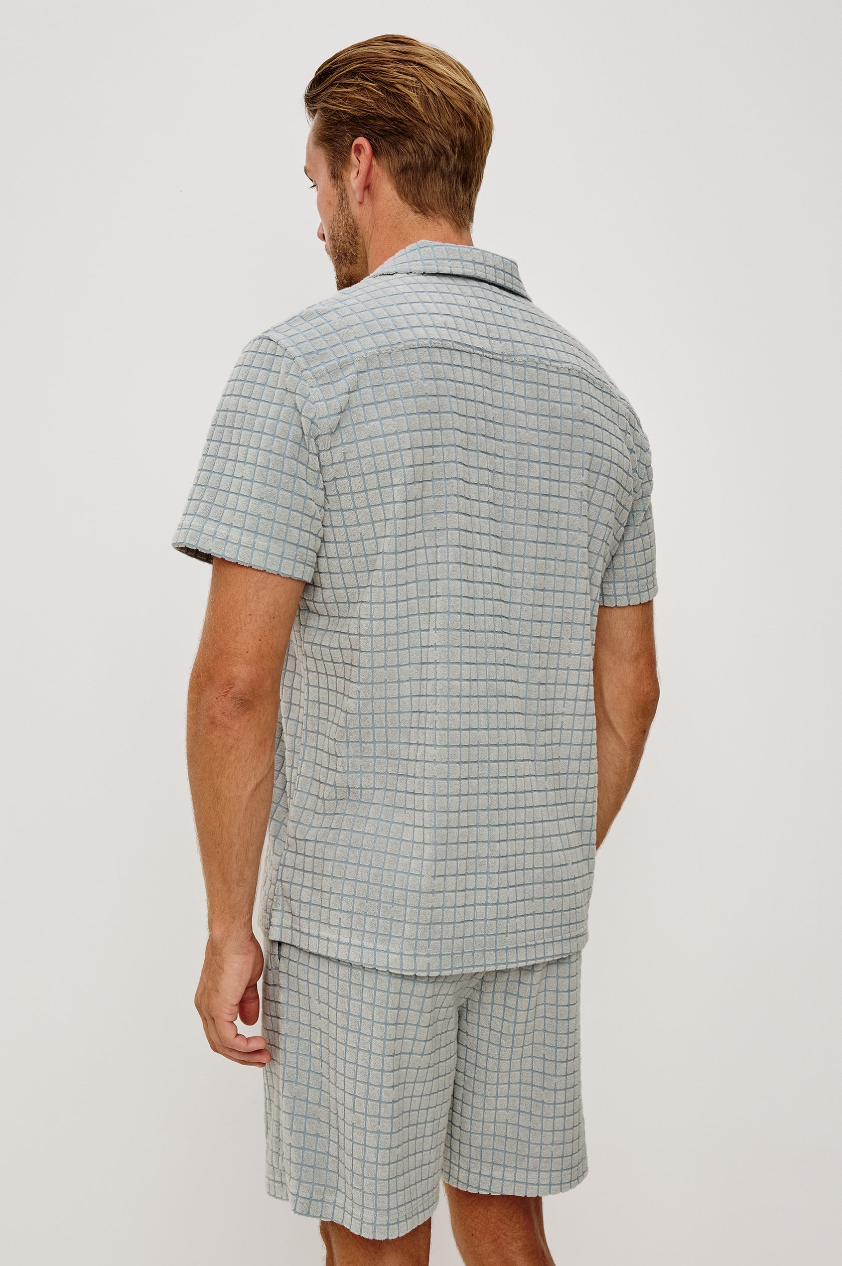 Maverick Short Sleeve Shirt in French Terry With Jacquard Pattern, Notched Collar, Front Buttons, and Classic Fit in Silver Line Blue Grid Colorway - Upper Body Back View Featured on Model