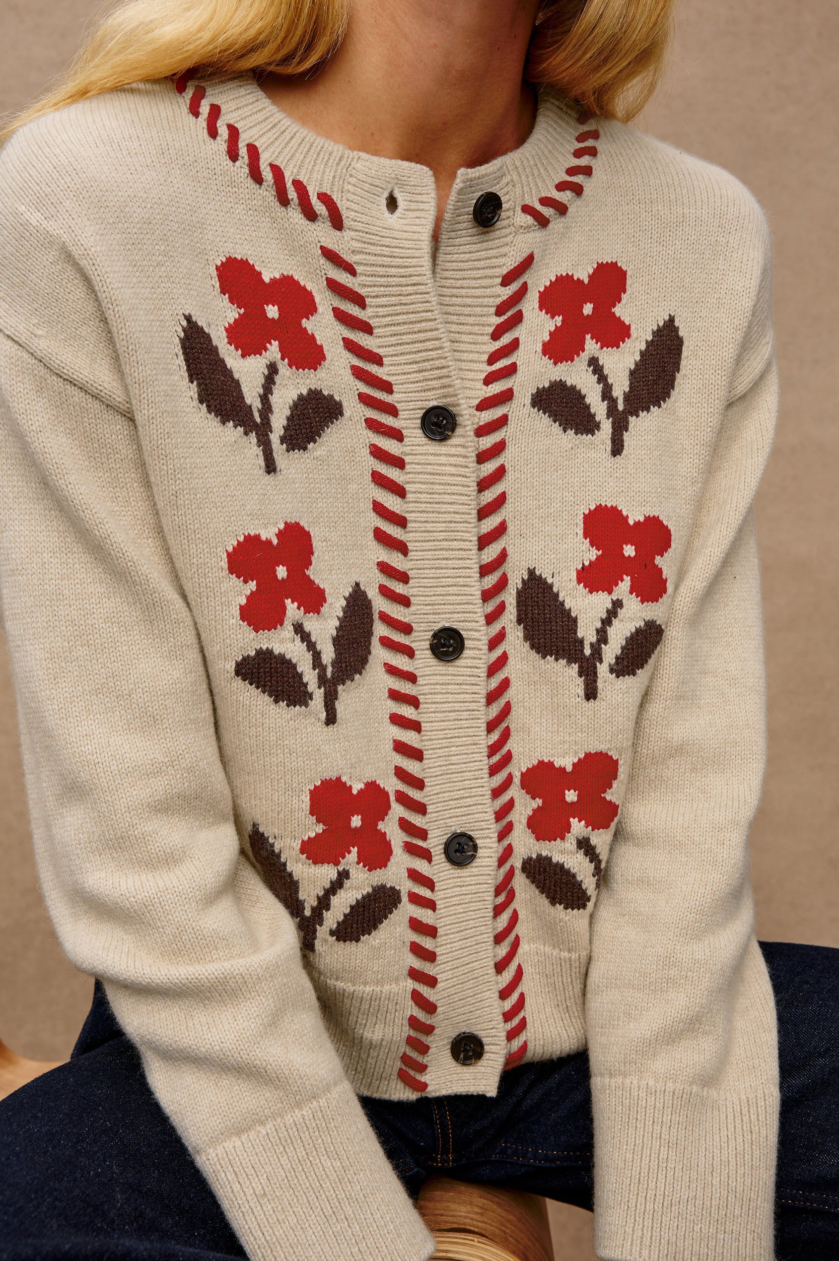 Mavie Long-Sleeve Cardigan with Button Closure, Crew Neck and Ribbed Trim in Carmine Floral Colorway with Carmine and Brown Flowers and Red Contrast Whip Stitching - Close Up View Featured on Model