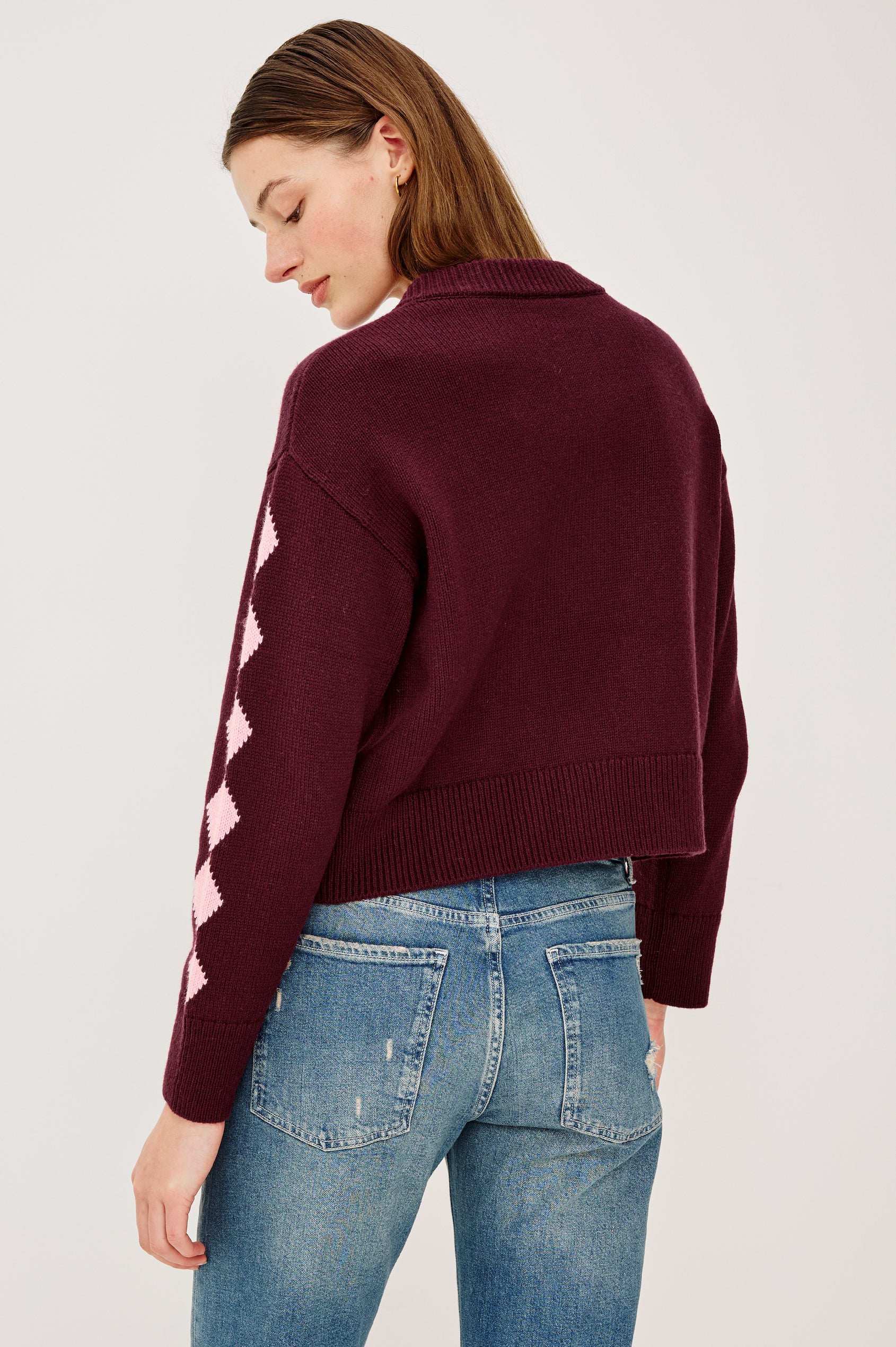 Mavie Cardigan in Wool Blend With Loose Relaxed Fit, Contrast Front Floral Motifs, Diamond Motifs at Long Sleeves, Crew Neckline, Front Buttons, and Ribbed Trim in Garnet Daisy Colorway - Upper Body Back View Featured on Model