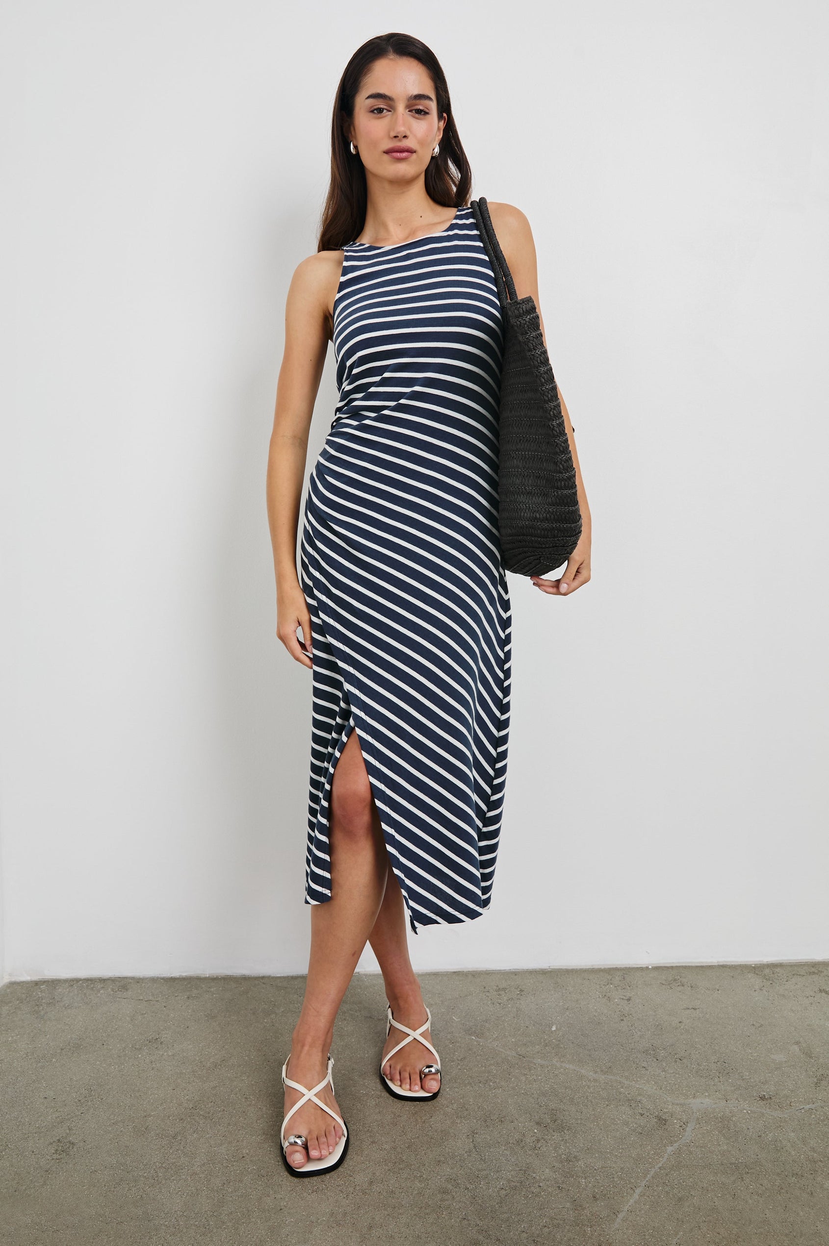 Max Wrap Dress with a Scoop Neck, Sleeveless, Gathering at Side Seam and Front Slit in Navy and White Nautical Stripe Colorway. Front View Shown on Model.